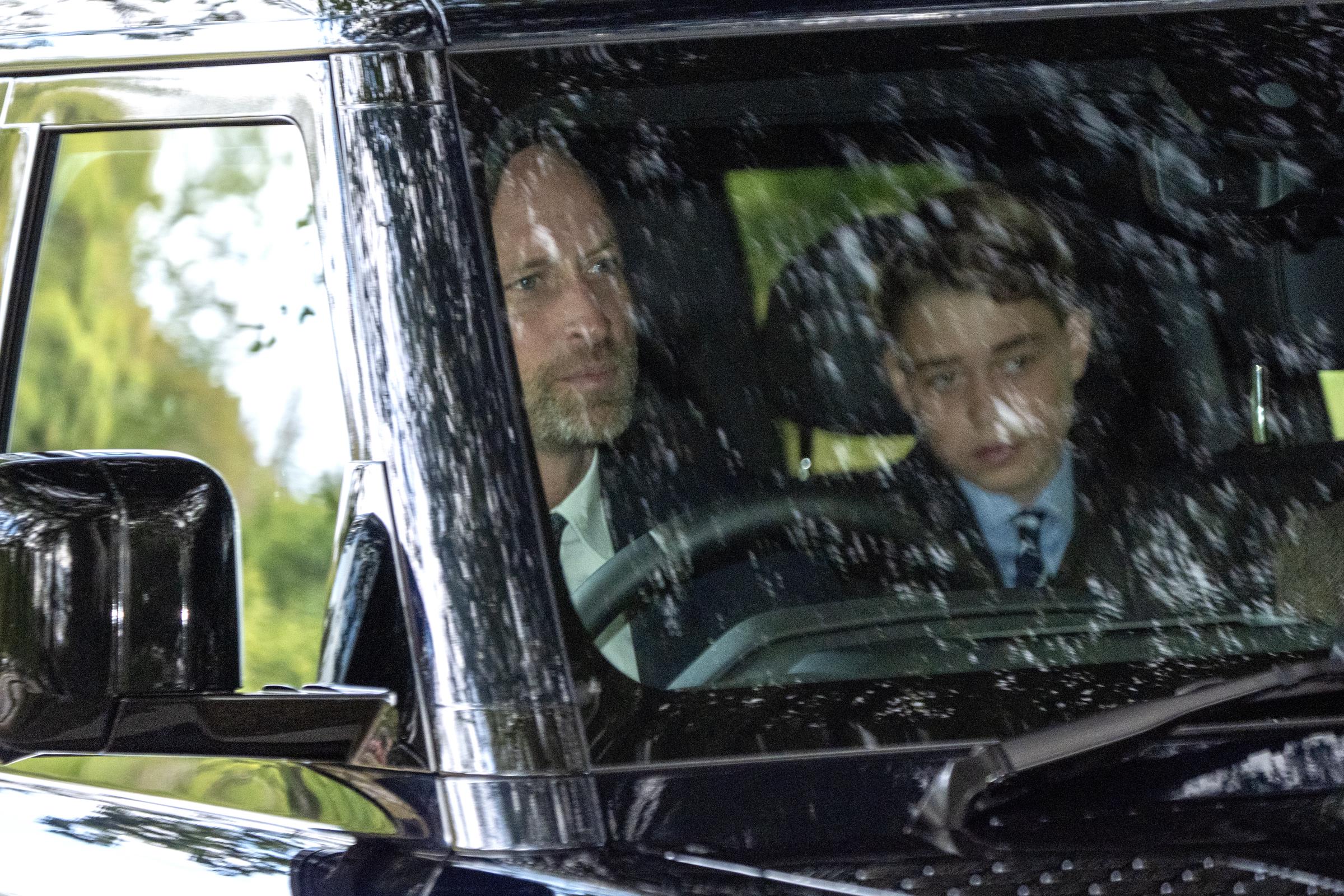 Prince William is pictured driving the car while Prince George sits alongside him, wearing a suit for the Balmoral outing. New photos of the young royal have sparked widespread concern among fans. | Source: Getty Images