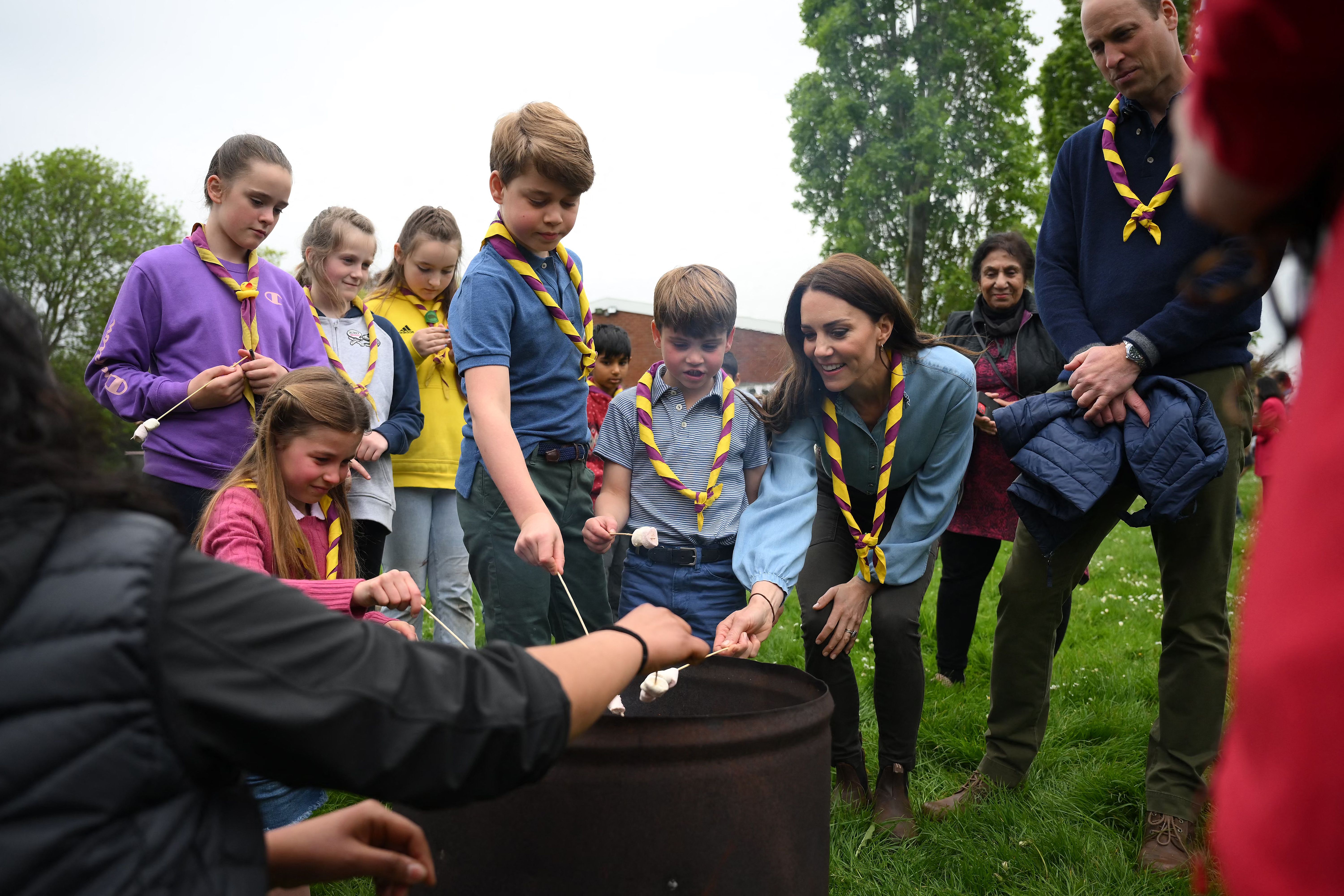 Prince William looks on as Princess Charlotte, Prince George, Prince Louis and Princess Catherine roast marshmallows on sticks during The Big Help Out on May 8, 2023. | Source: Getty Images