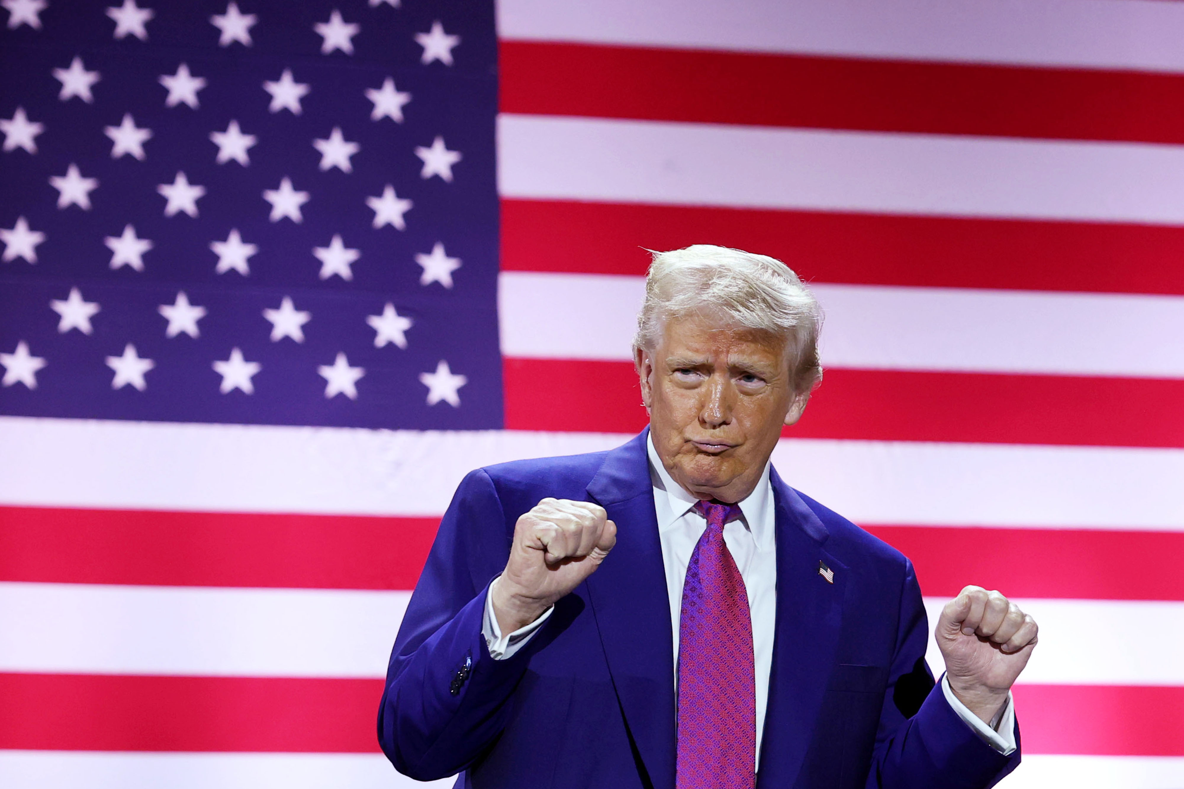 President Donald J. Trump gestures on stage as he tours the Al Udeid Air Base on May 15, 2025, in Doha, Qatar. | Source: Getty Images