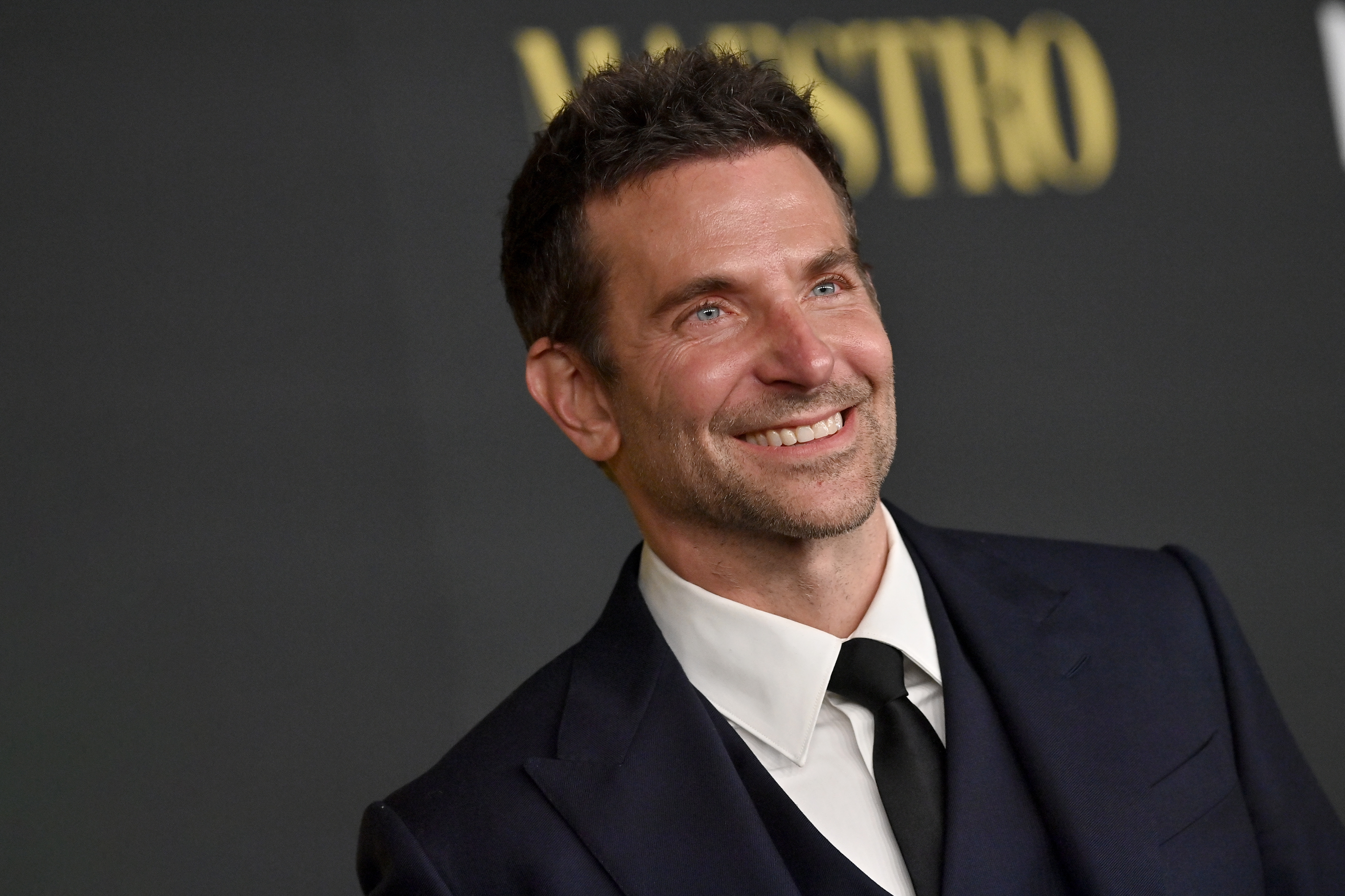 Cooper's face displayed laugh lines thanks to a prominent smile in this photo. He also had closely cropped, dark brown hair with slight silvering at the temples and a neat stubble as he attended Netflix's "Maestro" Los Angeles Photo Call at Academy Museum of Motion Pictures on December 12, 2023, in Los Angeles, California.