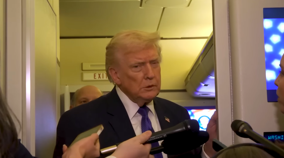 Donald Trump addressing reporters aboard Air Force One. | Source: YouTube/The White House
