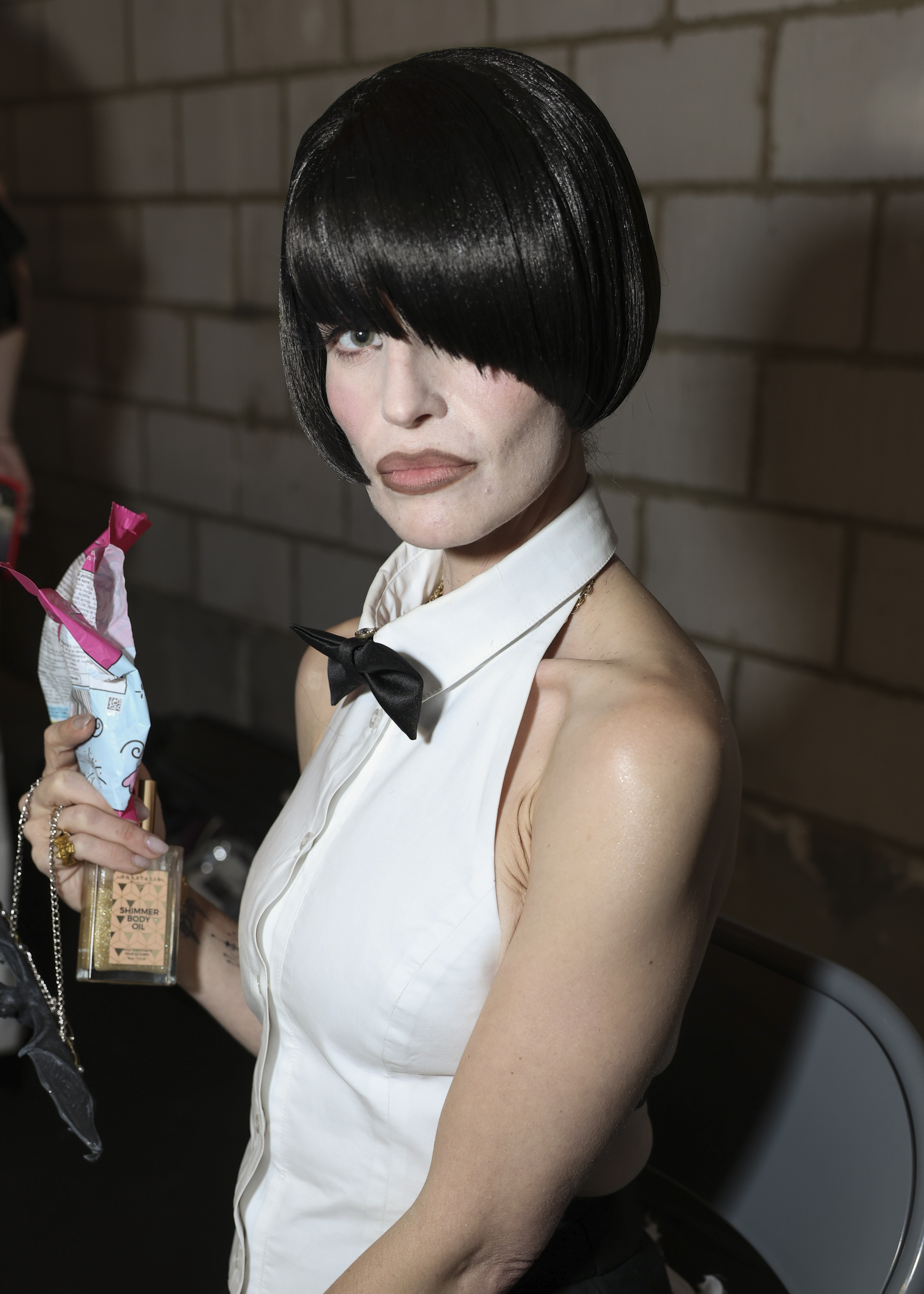 Kelly Osbourne poses backstage in her dramatic black bob wig and runway look ahead of Natasha Zinko's Spring/Summer 2027 presentation during London Fashion Week. | Source: Getty Images
