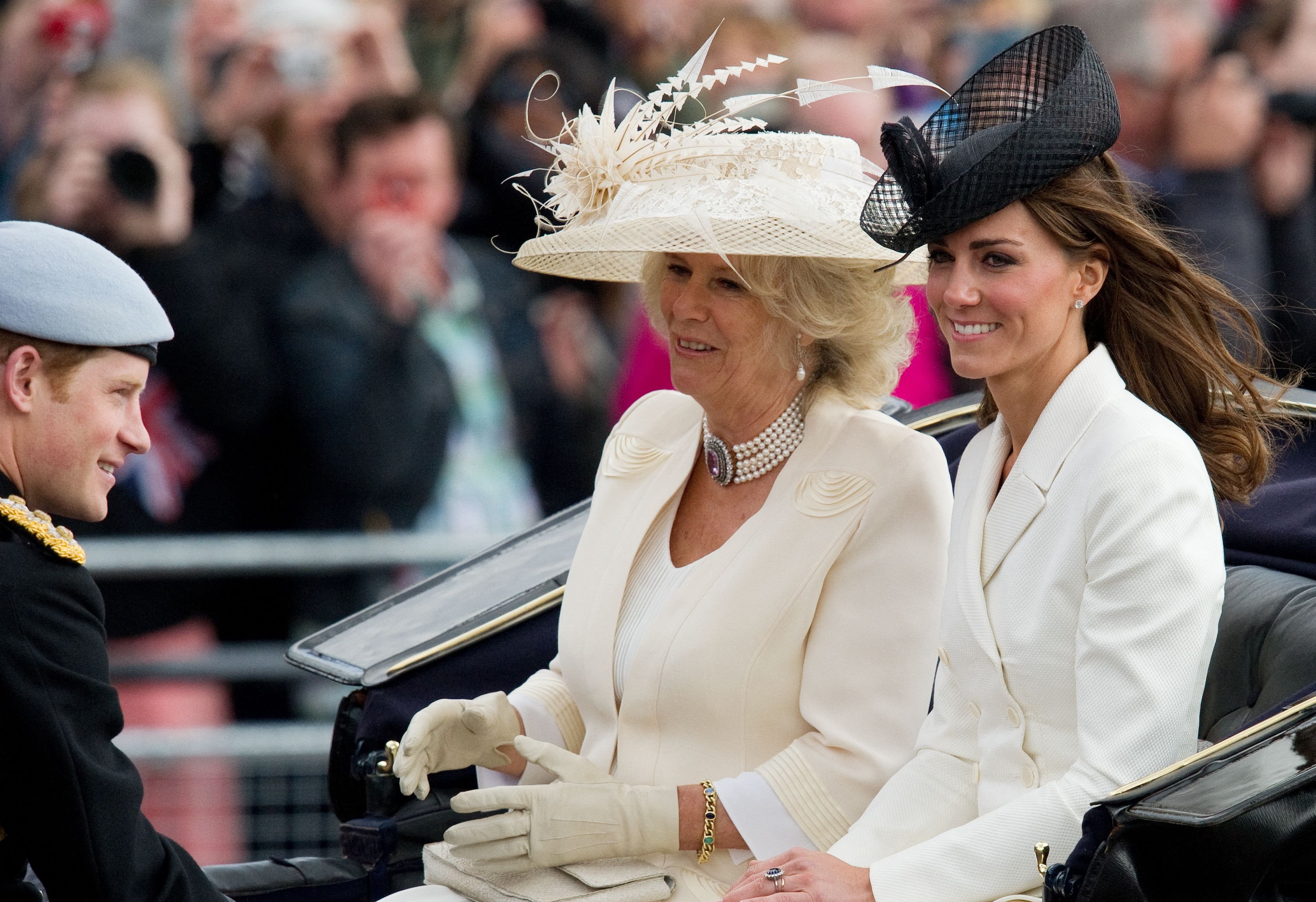 Prince Harry, Duchess Camilla, and Duchess Kate travel back to Buckingham Palace after the Queen's Birthday Parade in London on June 11, 2011 | Source: Getty Images