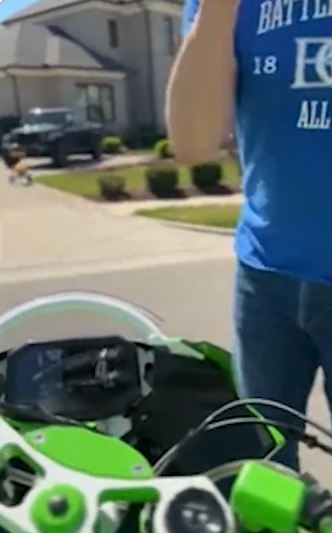 Alan Ritchson turns back toward his motorcycle as if to leave, but Ronnie Taylor remains in front of him, blocking his path. | Source: X/TMZ