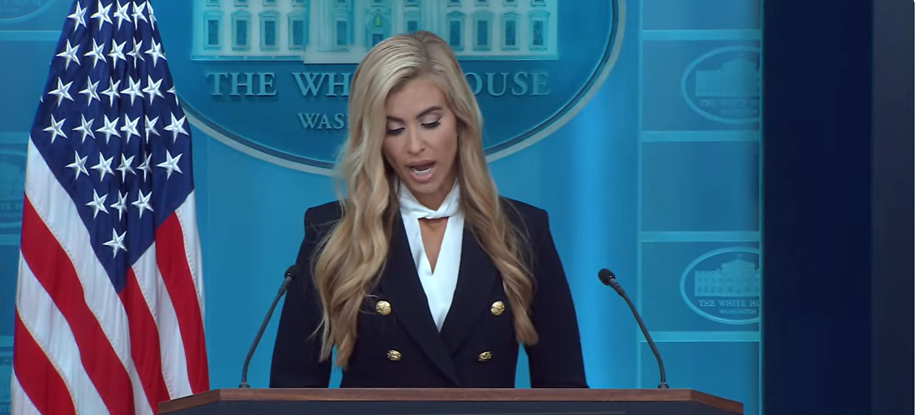 Katie Zacharia looks down at her notes while responding to a reporter's question about U.S. Ambassador to Greece Kimberly Guilfoyle during her first White House press briefing. | Source: YouTube/The White House