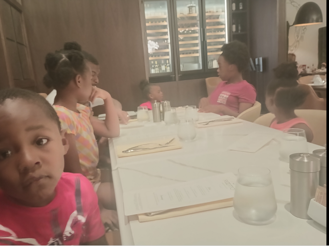 A candid photo of Shamar Elkins’s children shows them gathered around a restaurant table, menus and glasses set neatly as they sit mid-conversation. | Source: Facebook/Shaneiqua Elkins