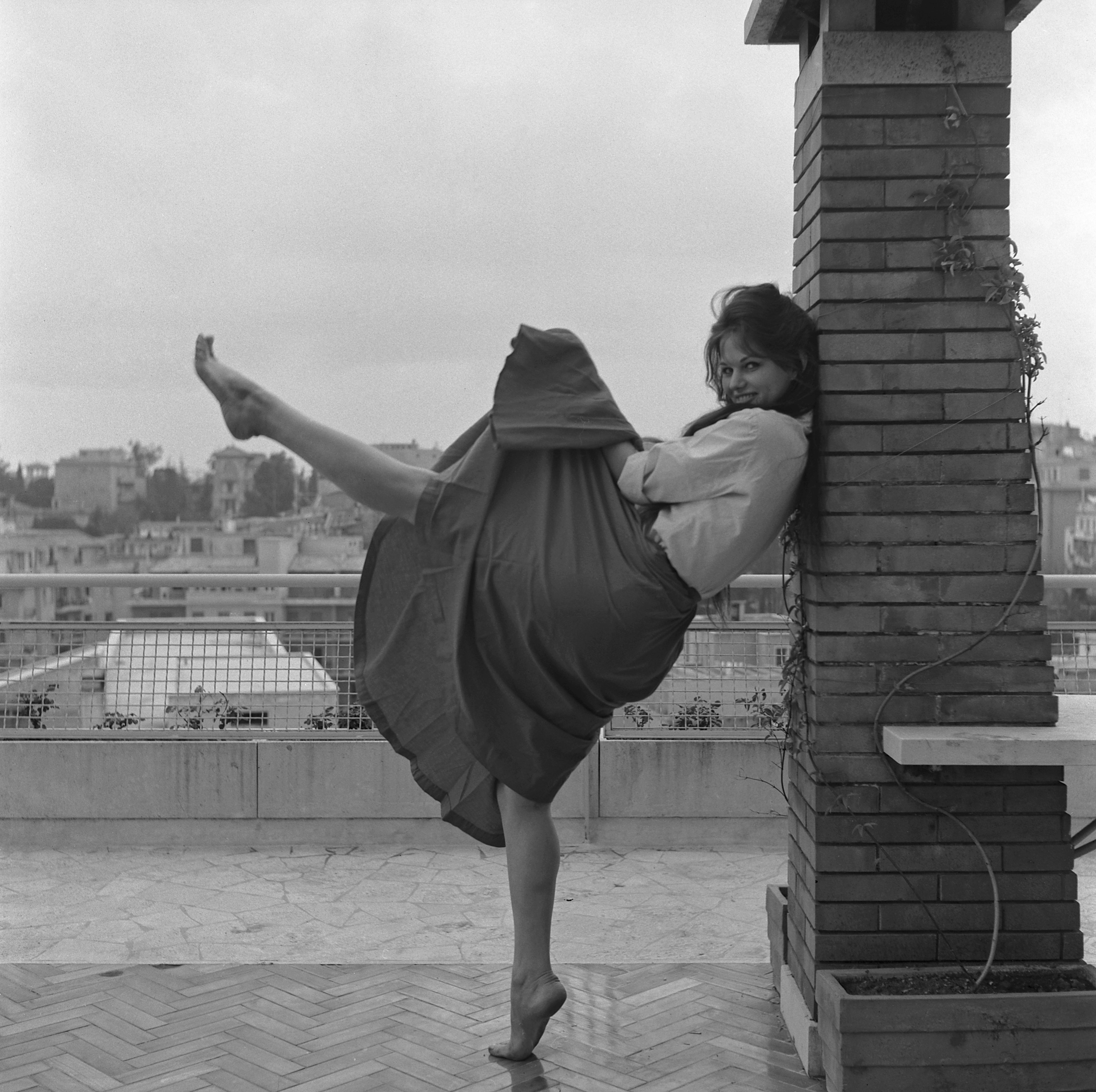 Claudia Cardinale pictured dancing on a terrace in Rome, Italy on January 1, 1959. | Source: Getty Images