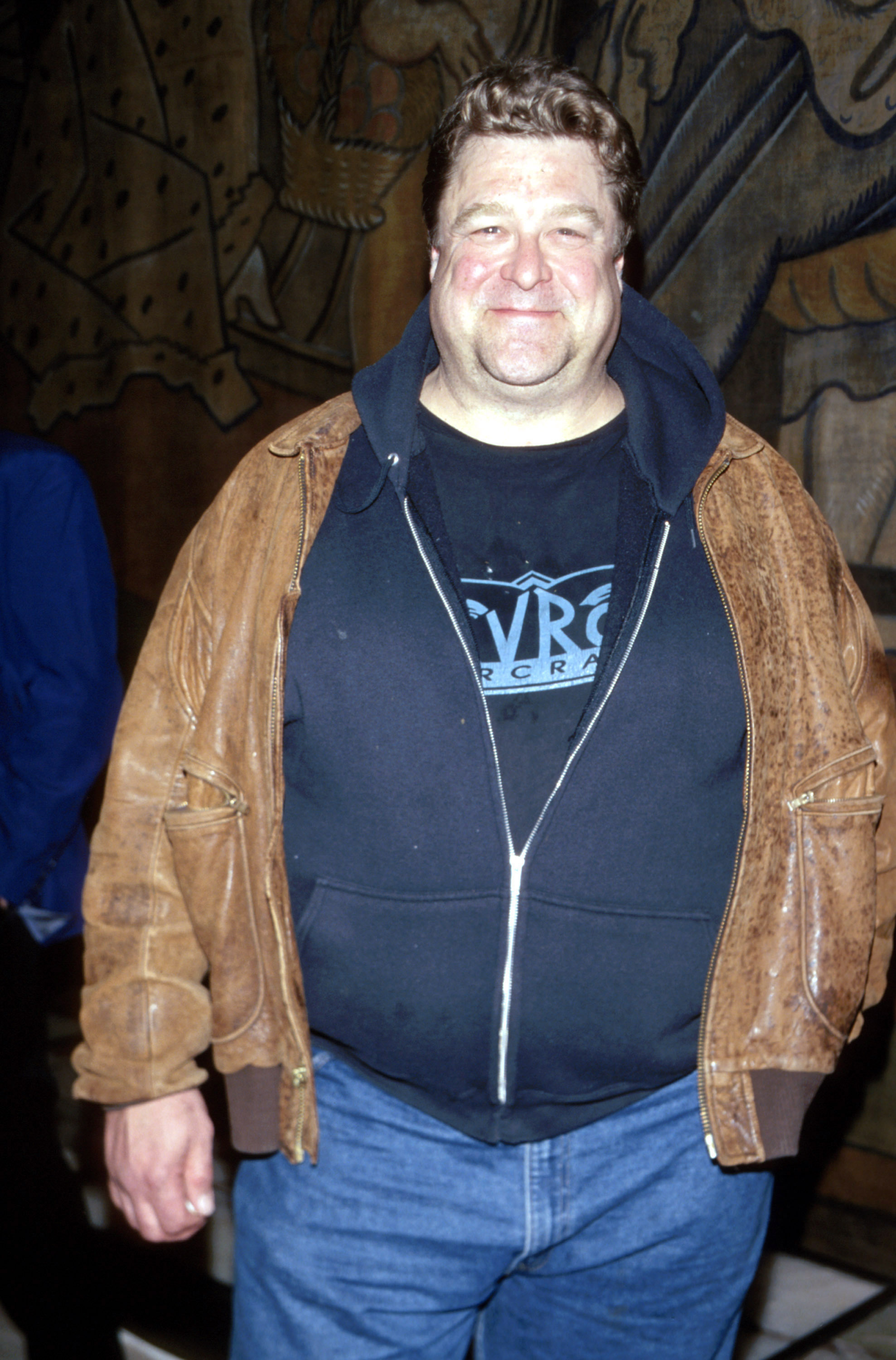 Actor John Goodman was spotted in a blue T-shirt with wordings tucked into denim trousers. He wore a deep blue hoodie over the T-shirt and finished off his look with a brown long-sleeve jacket. The actor posed with his left hand tucked into the left pocket of the denim.