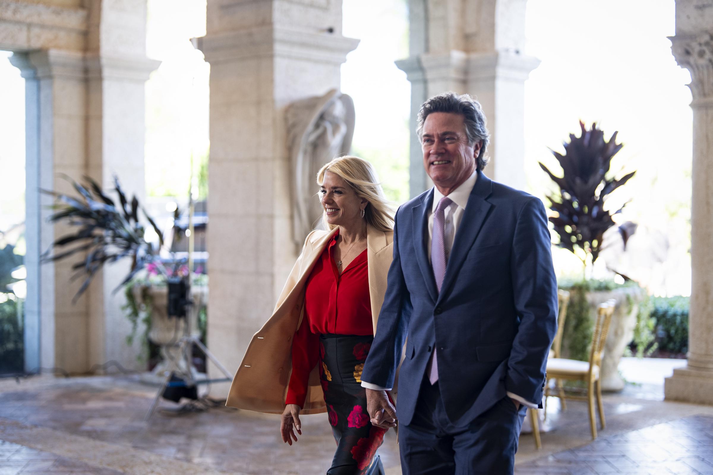 Pam Bondi and John Wakefield smile as they arrive at Mar-a-Lago in Palm Beach, Florida, on February 1, 2026 | Source: Getty Images