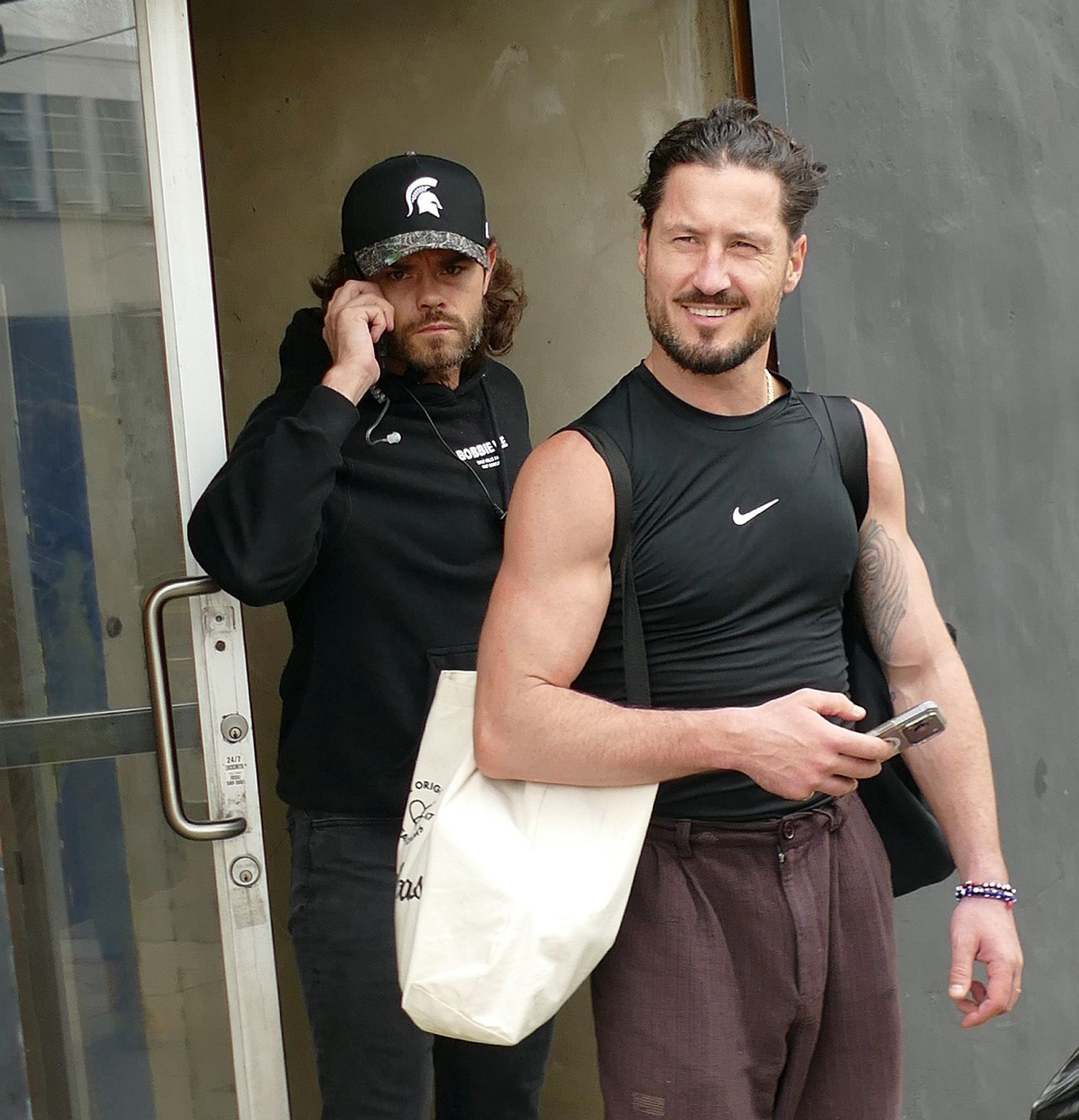 Val Chmerkovskiy smiles as he steps out of rehearsal studios for "Dancing with the Stars" in Los Angeles on October 10, 2026. Coming off a string of strong performances with partner Jenna Dewan, the veteran ballroom professional appeared focused on keeping their season 35 momentum alive. Days later, an ill-advised social media post referencing a tense judges' critique would result in his unprecedented one-week suspension, keeping him off the broadcast for Dedication Night. | Source: Getty Images