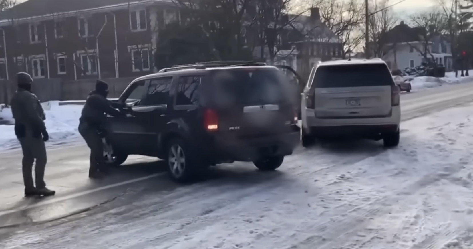 ICE agents near Renee Nicole Good's car on January 7, 2026 | Source: YouTube/NBC News