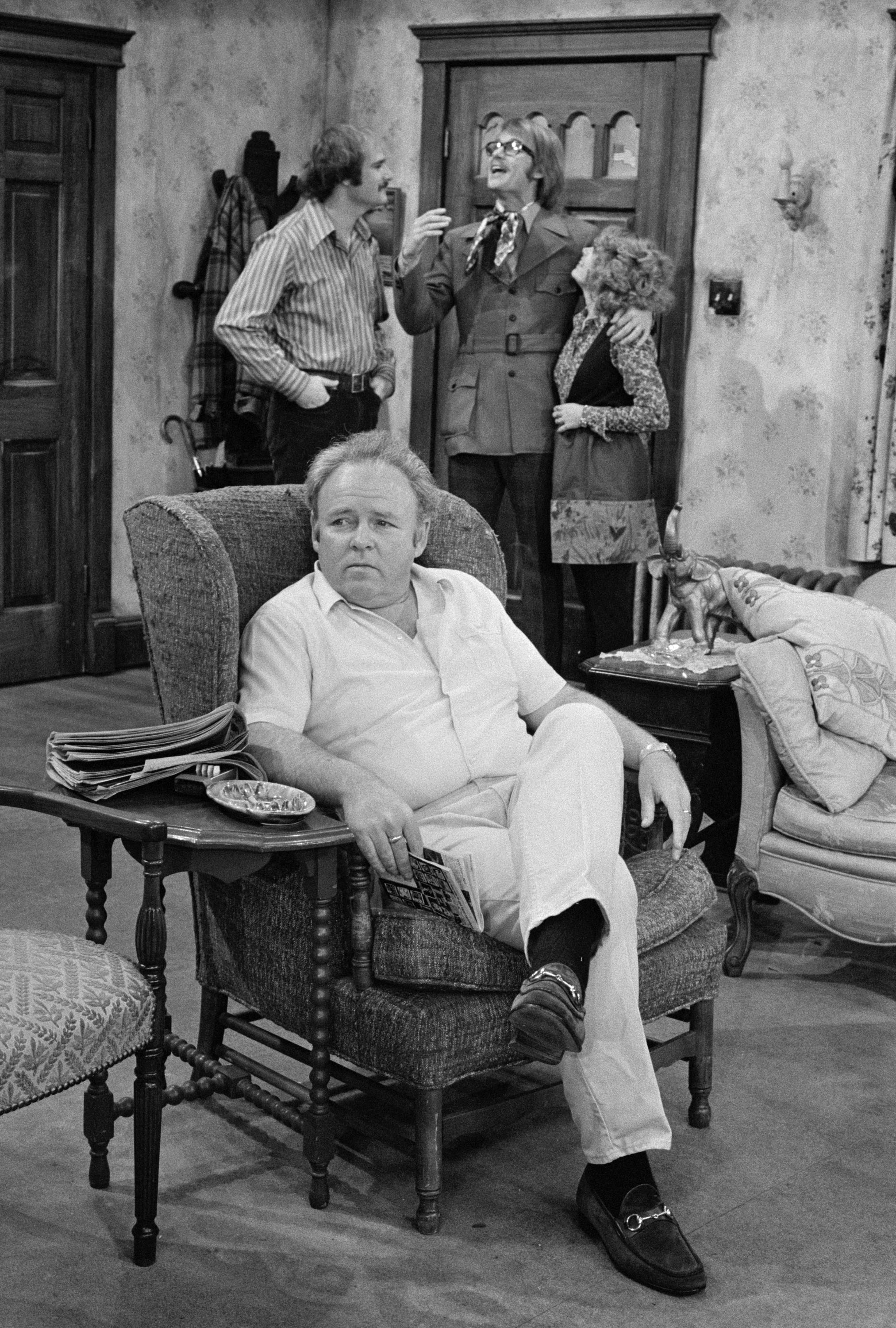 Carroll O'Connor as Archie Bunker, sitting, Rob Reiner as Mike Stivic, back left, Anthony Geary as Roger, back center, and Sally Struthers as Gloria Stivic, in the CBS television series "All in the Family" on January 12, 1971 | Source: Getty Images