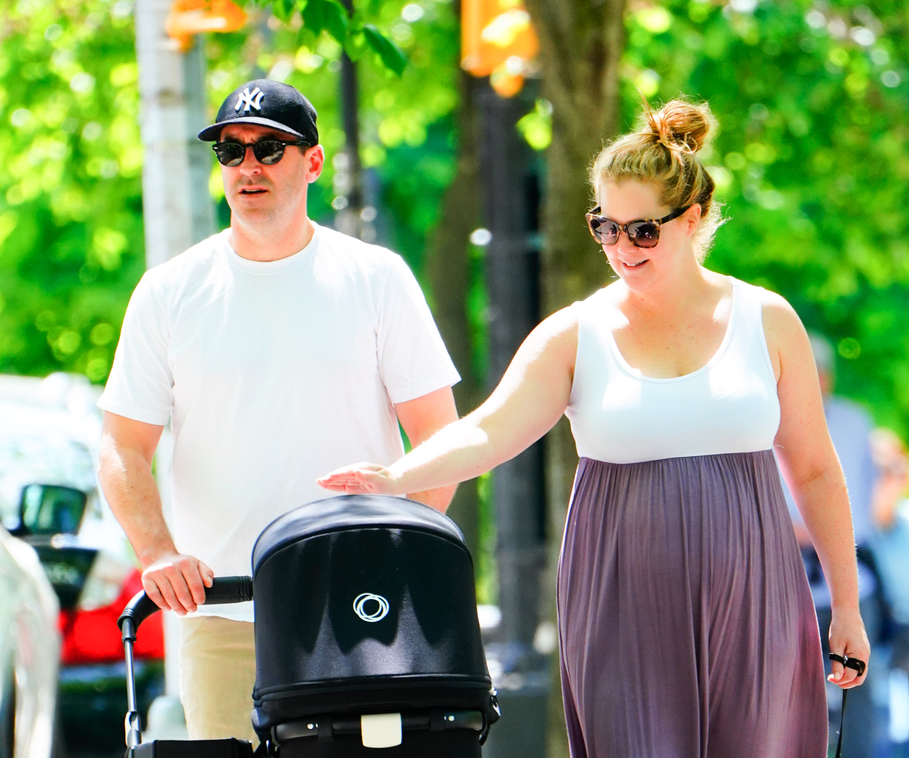 Amy Schumer and Chris Fischer take baby Gene Attell Fischer and their dog to the park on May 18, 2019, in New York City | Source: Getty Images