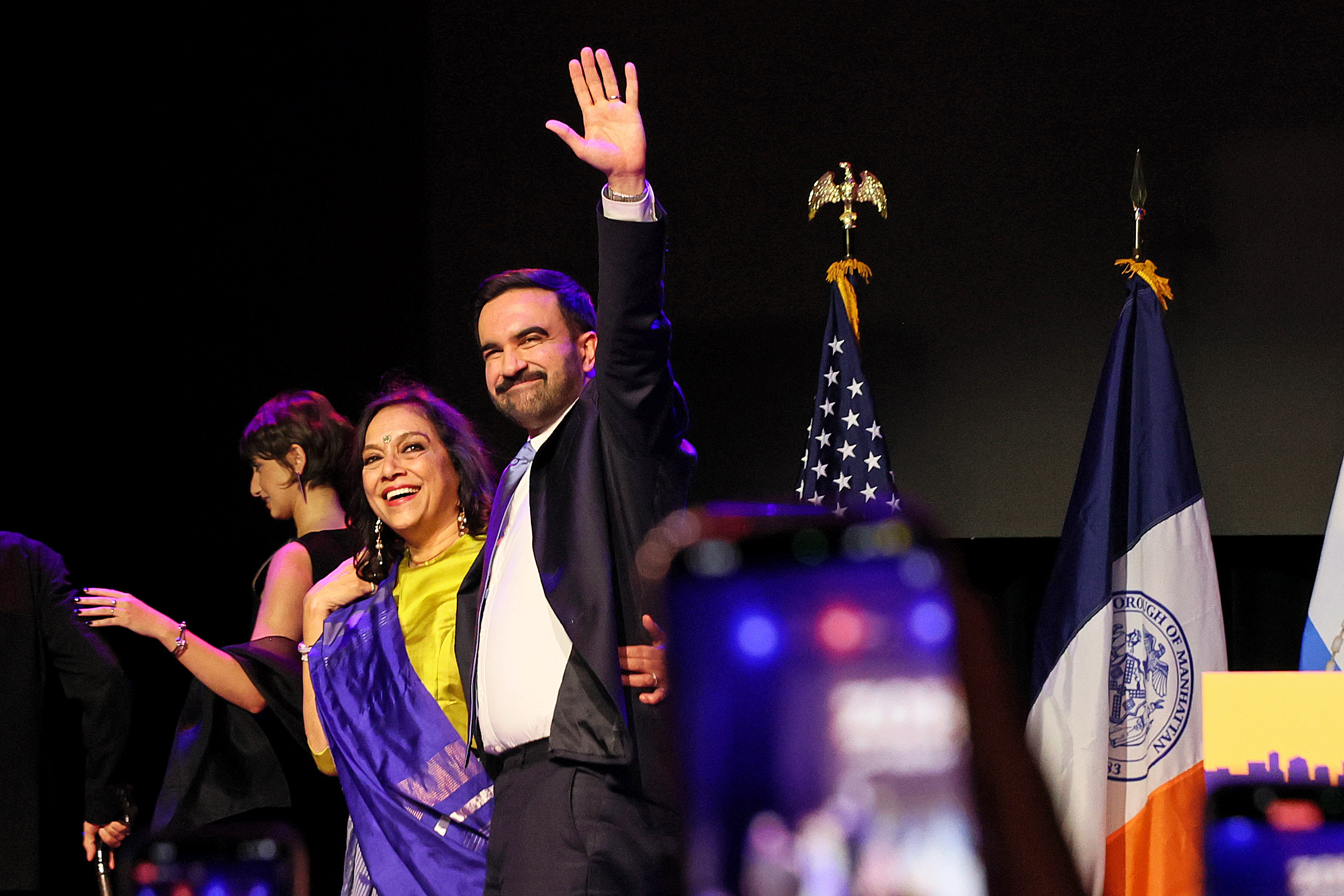 Zohran Mamdani departs with his mother Mira Nair (C) after delivering remarks at his election night watch party at the Brooklyn Paramount on November 4, 2025. | Source: Getty Images