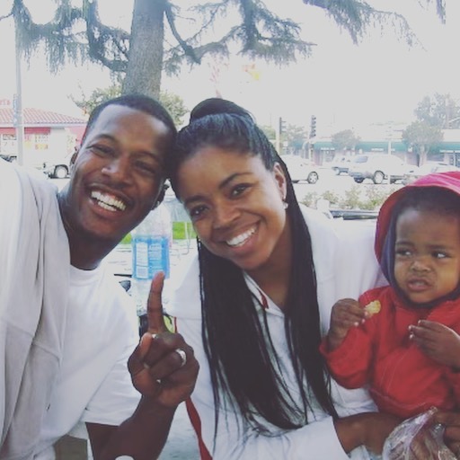 Flex Alexander and Shanice smiling for a photo with one of their kids, posted on August 31, 2021. | Source: Instagram/flexaforeal