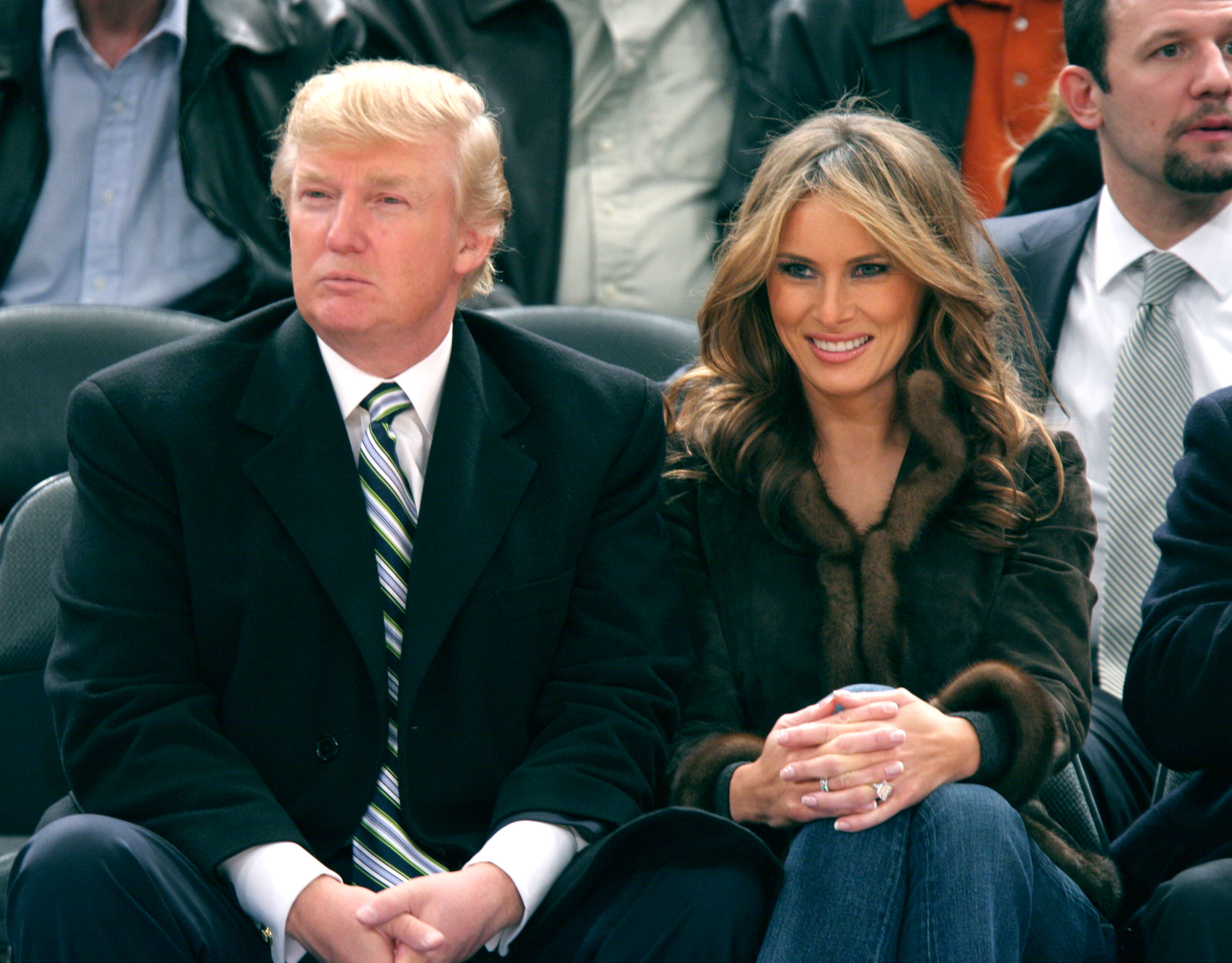 Donald Trump's hair appears noticeably lighter and more golden by March 2005 as he sits beside Melania Trump at a Miami Heat vs. New York Knicks game at Madison Square Garden.
