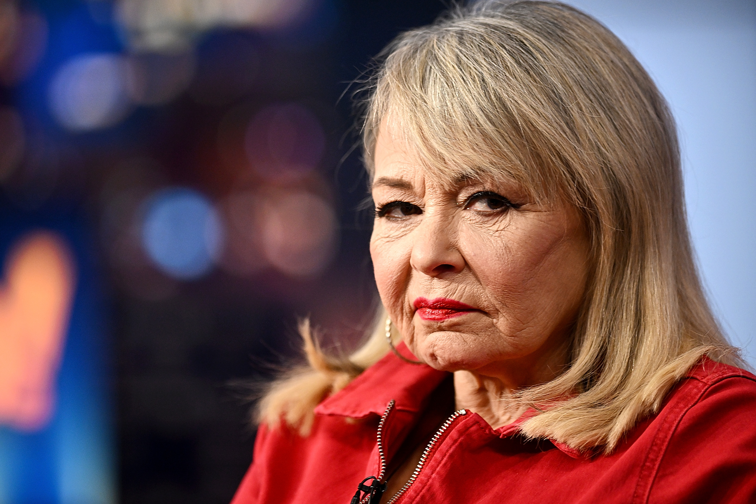 A close-up from the same appearance captured Roseanne's platinum-blonde hairstyle and signature red lipstick, offering another point of comparison as fans now weigh her latest silver-haired transformation.
