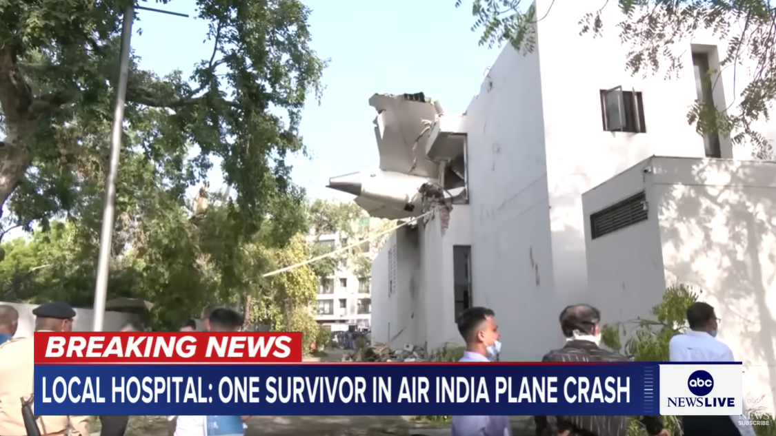 Part of the aircraft's tail protrudes from the wall of a college building, marking the point of impact, posted on June 12, 2025. | Source: YouTube/ABCNews