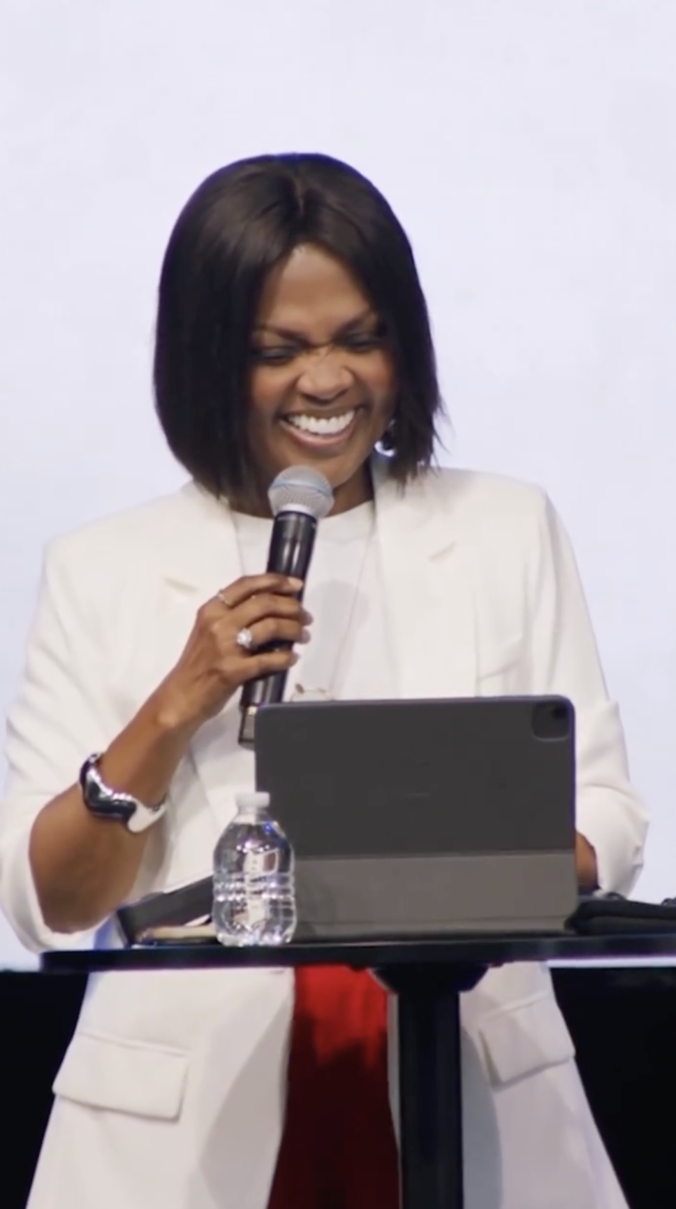 CeCe Winans laughs while looking down beside a microphone during a recent appearance shared on Instagram. | Source: Instagram/cecewinans