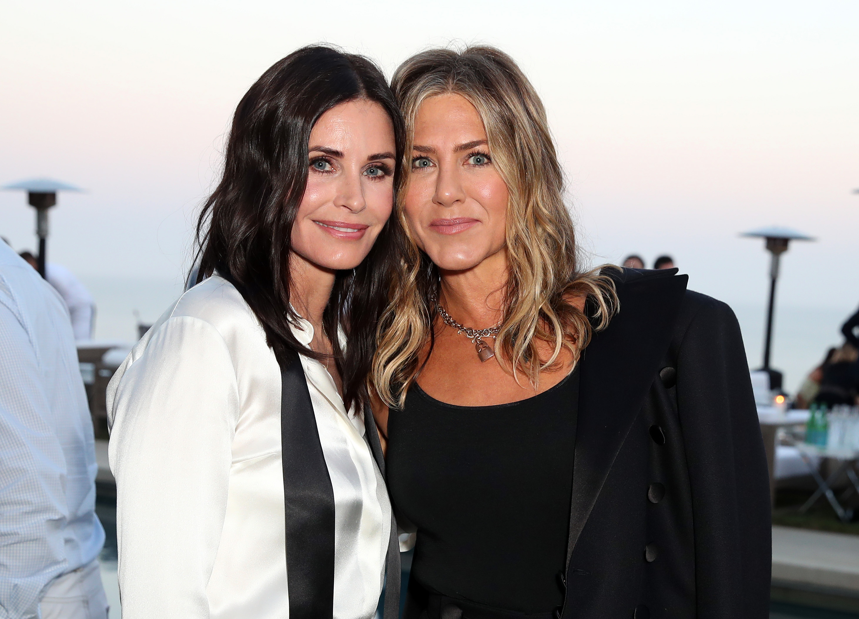 Courteney Cox and Jennifer Aniston at the Chanel NRDC dinner in Los Angeles, California. Their faces now show subtle differences, Aniston’s cheeks appear fuller, their chins vary, and their smiles angle differently, yet both radiate beauty.