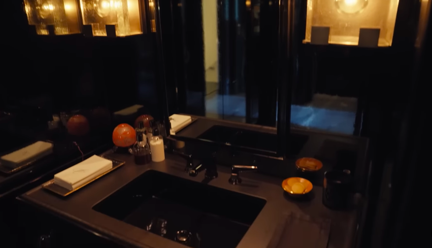 The all-black bathroom became even more memorable when Kelly and Mark revealed they had matching black toilet paper. Kelly said white toilet paper looked strange in the space, while Mark admitted the black version did not feel normal. | Source: YouTube/Architectural Digest