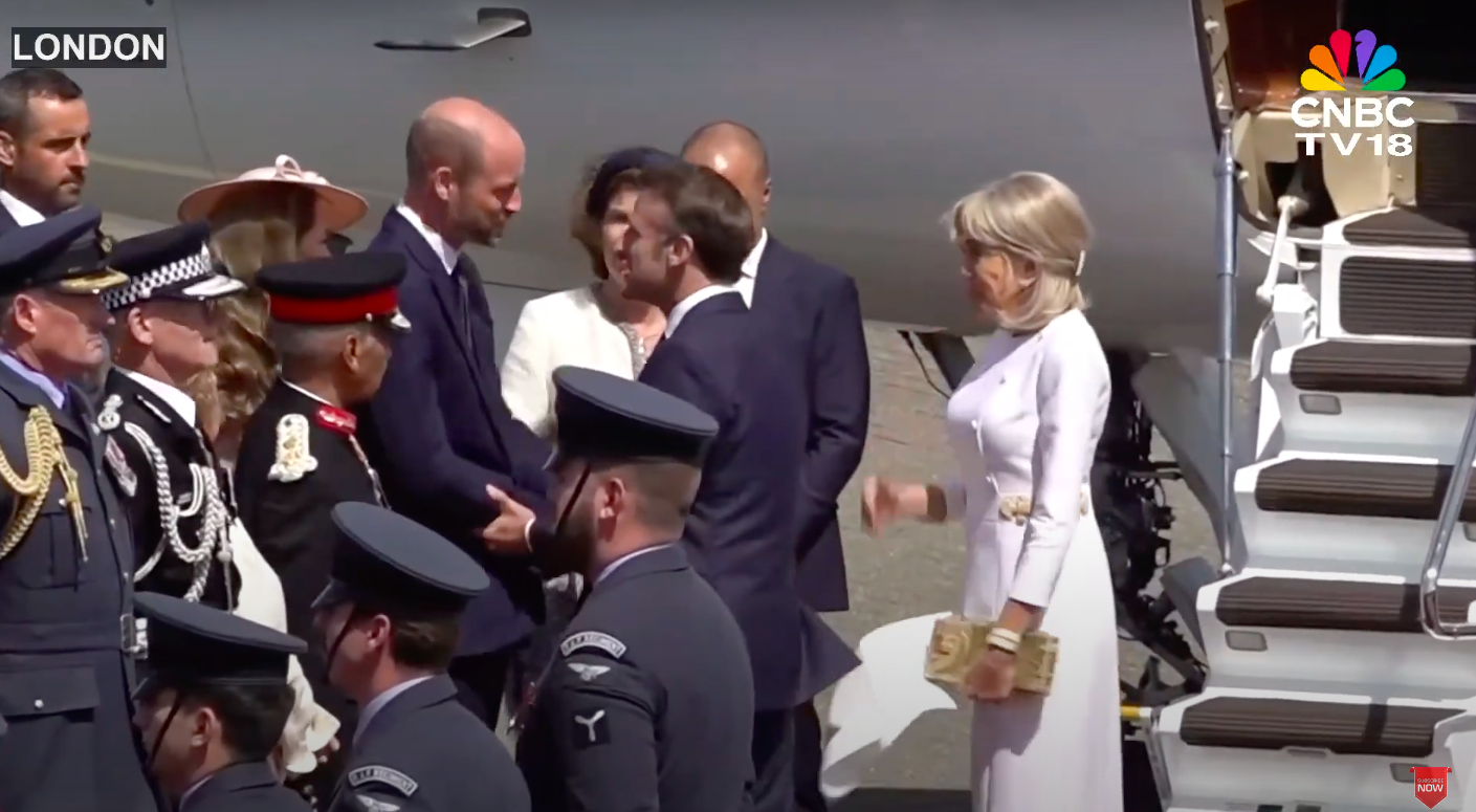The Prince of Wales and Emmanuel Macron shaking hands as Brigitte Macron and other people surround them, posted on July 8, 2025. | Source: YouTube/CNBC-TV18