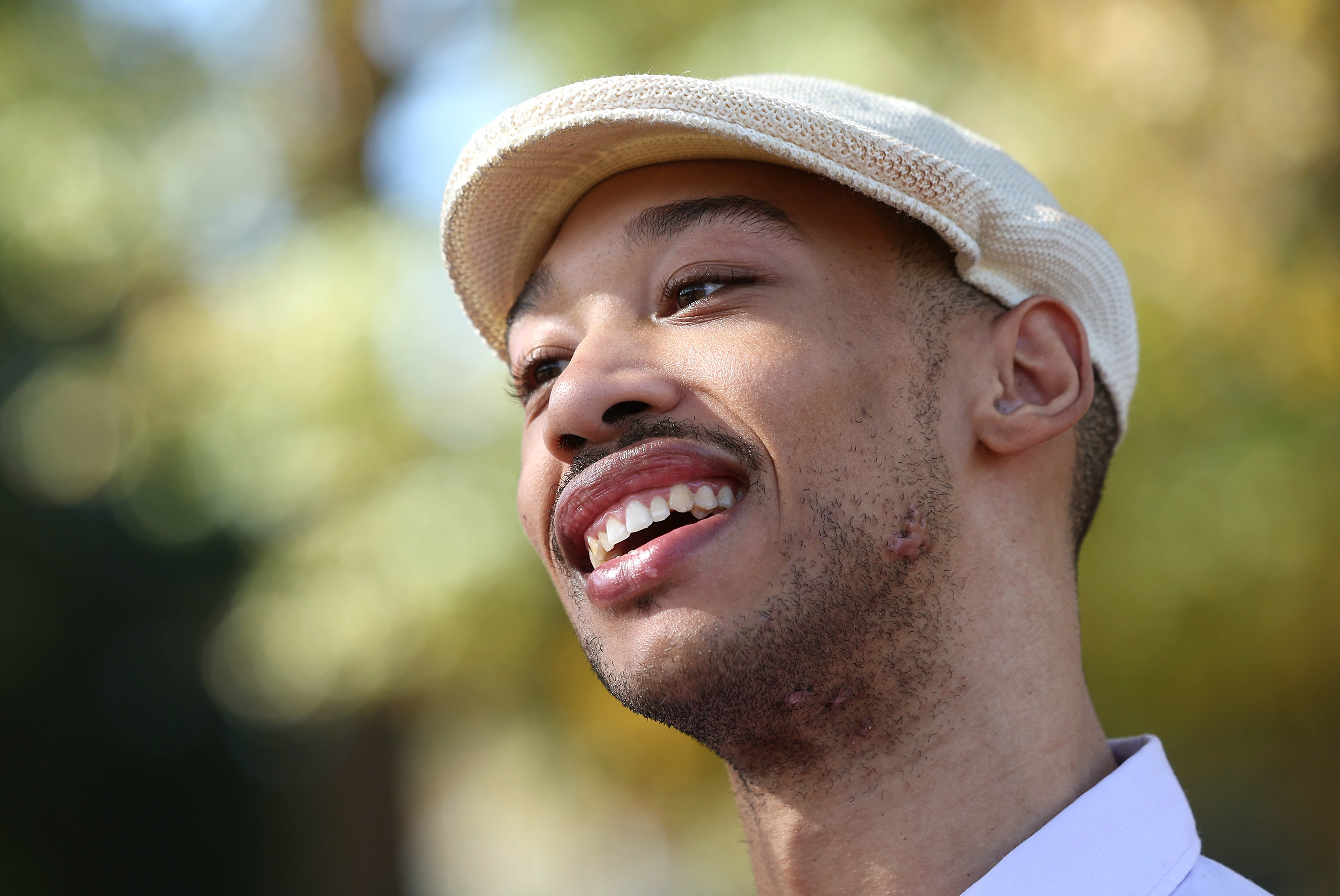 Chancellor Lee Adams smiled during an interview at Freedom Park in Charlotte, North Carolina, on October 30, 2024, wearing a light-colored cap as he spoke about his life as an adult. Nearly 25 years had passed since Chancellor survived the shooting that ultimately killed his mother and left him with cerebral palsy and brain damage requiring lifelong assistance.