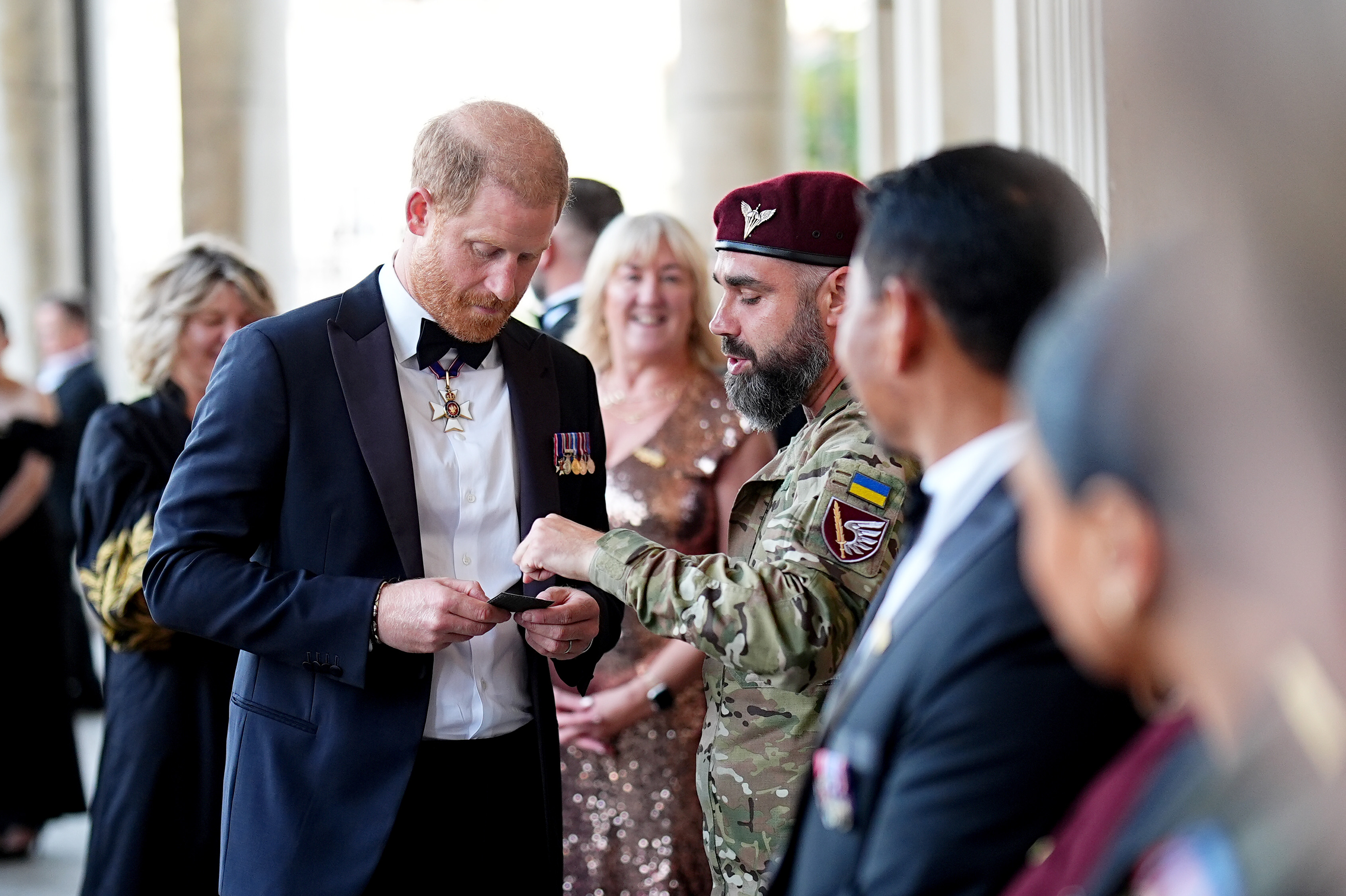Prince Harry, Duke of Sussex receives a military patch from a guest upon arrival at the Invictus Games Foundation's inaugural Invictus Spirit Awards on September 17, 2026 in London, England. | Source: Getty Images
