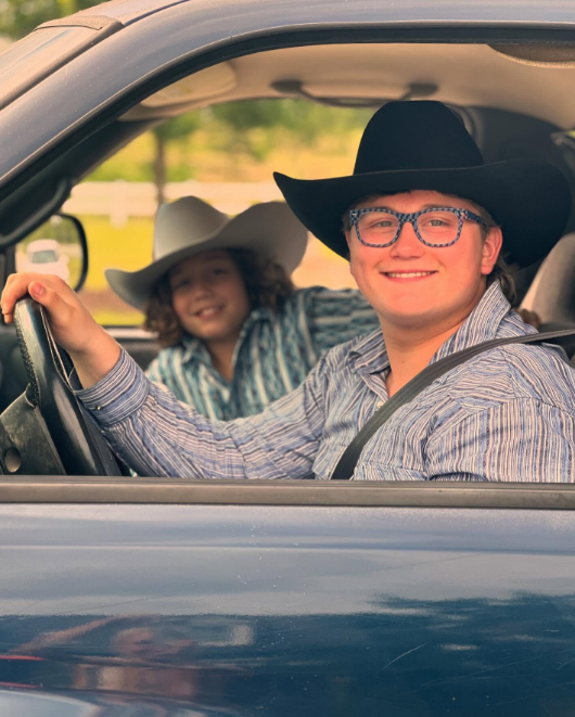Zuma Rossdale smiled from behind the wheel in a classic black cowboy hat and striped western shirt alongside his younger brother Apollo Rossdale in an image shared on October 19, 2024. | Source: Instagram/zuma_rossdalemusic