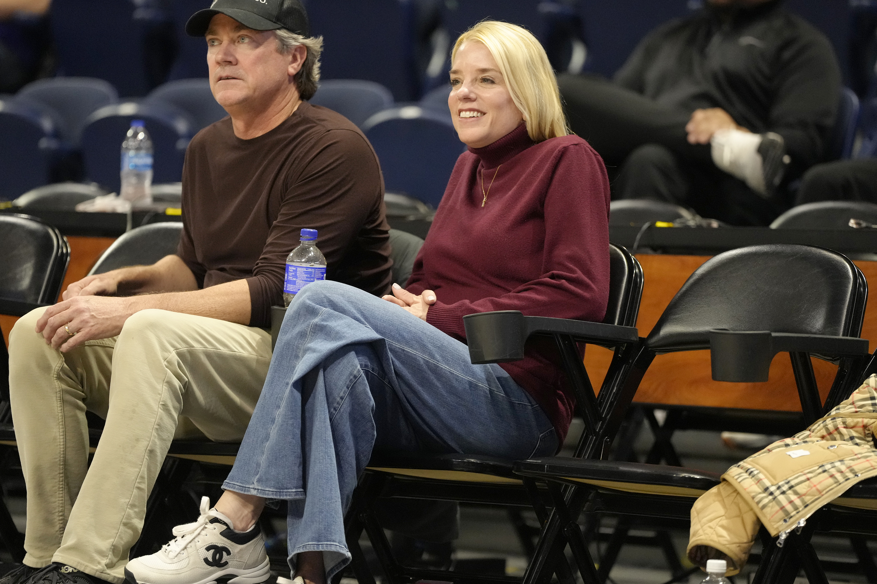 Pam Bondi and her then-husband, Garret Barnes, watch a CAA Tournament semifinal game in Washington, D.C. on March 10, 2025. | Source: Getty Images
