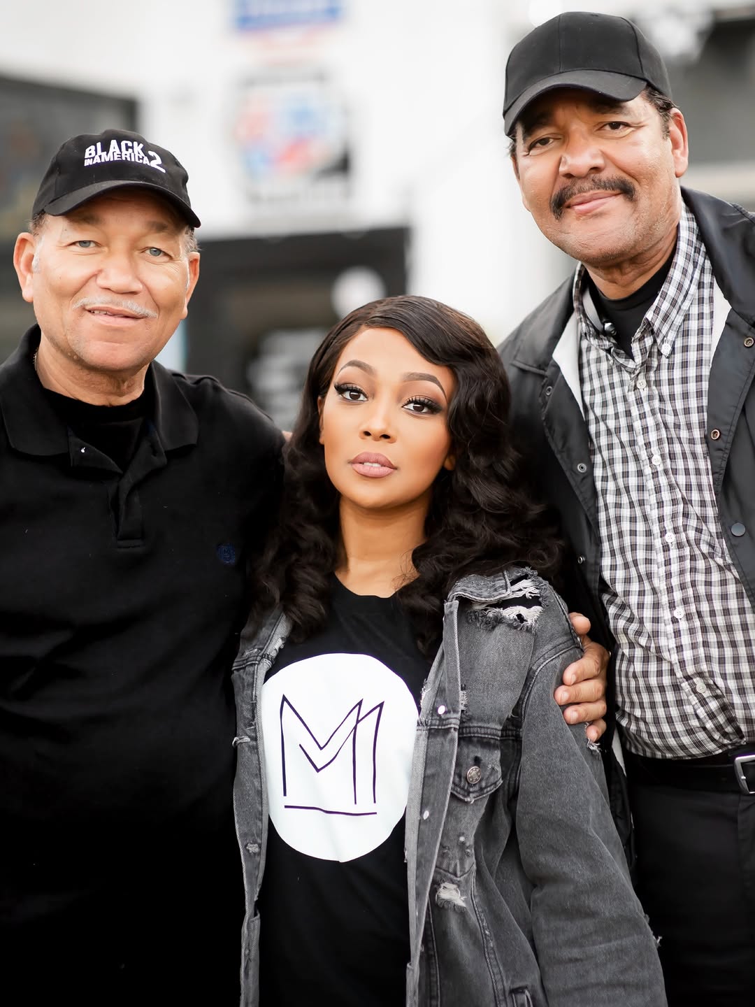 A photo of Monica, her dad, M.C. Arnold Jr., and another loved one. | Monica smiling for a photo with her dad. | Source: Instagram/monicadenise
