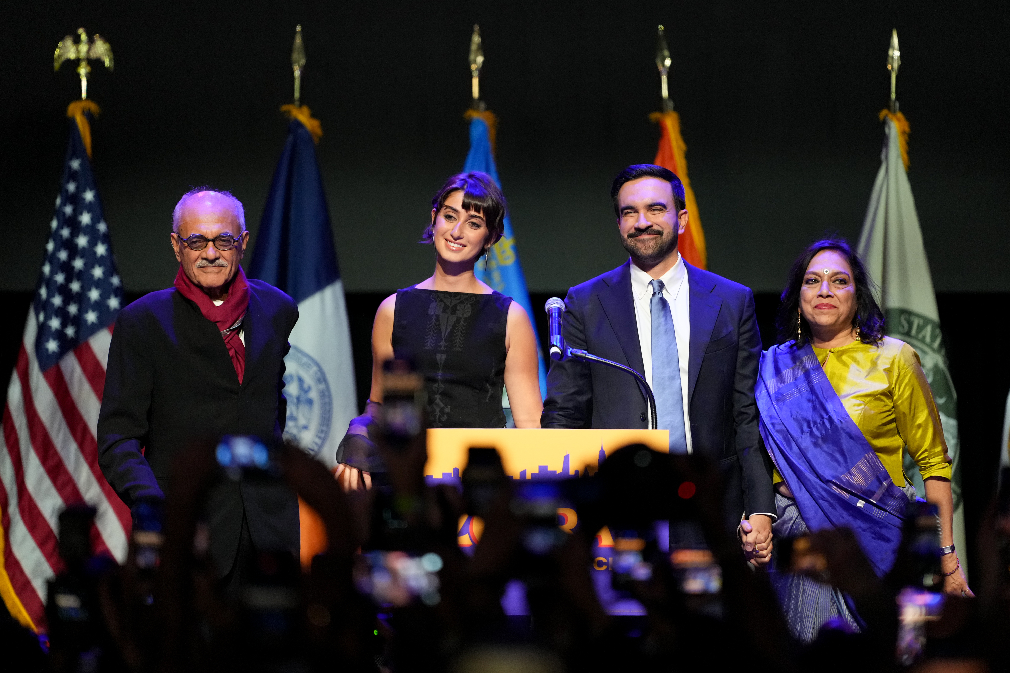 Zohran Mamdani is joined by his wife Rama Duwaji and his parents Mahmood and Mira Nair, during an election night event at The Brooklyn Paramount Theater on November 4, 2025. | Source: Getty Images