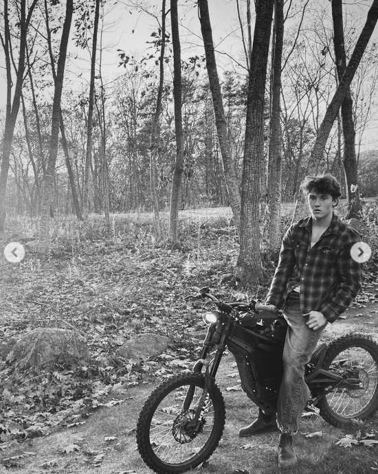 Darby Dempsey standing over a motorcycle, from a post dated November 26, 2025 | Source: Instagram/jilliandempsey