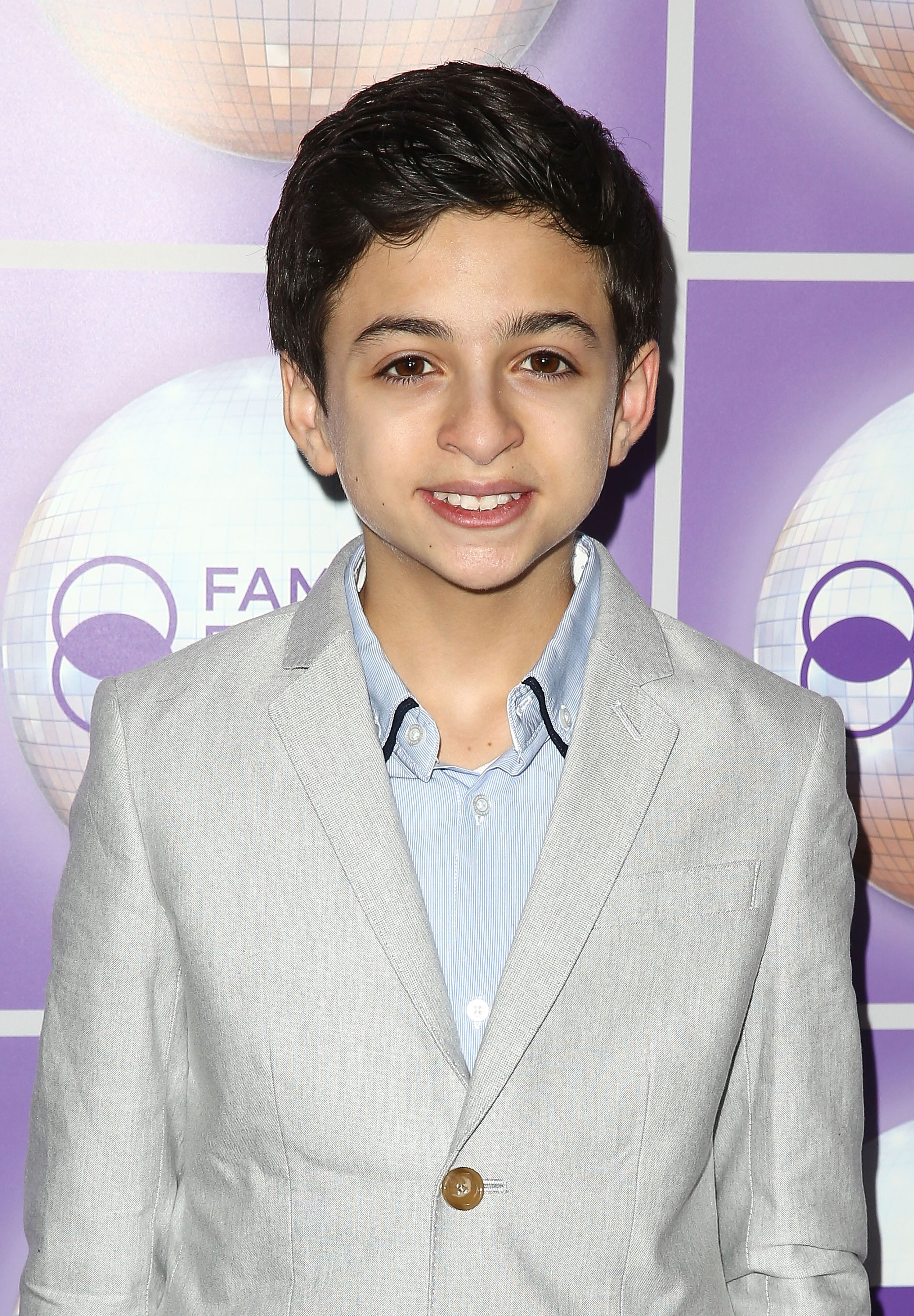 J.J. Totah attends the Family Equality Council's Los Angeles Awards Dinner at The Beverly Hilton Hotel in Beverly Hills, California, wearing a light gray suit jacket over a pale blue striped shirt. | Source: Getty Images