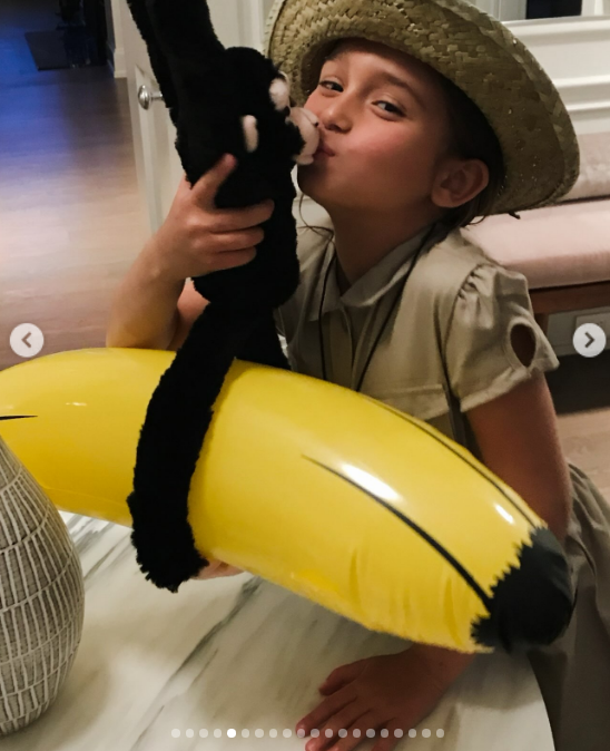 Dressed up in an explorer costume, a young Arabella struck a cheeky pose with a woven straw safari hat, kissing a black plush monkey wrapped around an inflatable yellow banana. The adorable snapshot captured her vibrant, playful personality as a child. | Source: Instagram/ivankatrump
