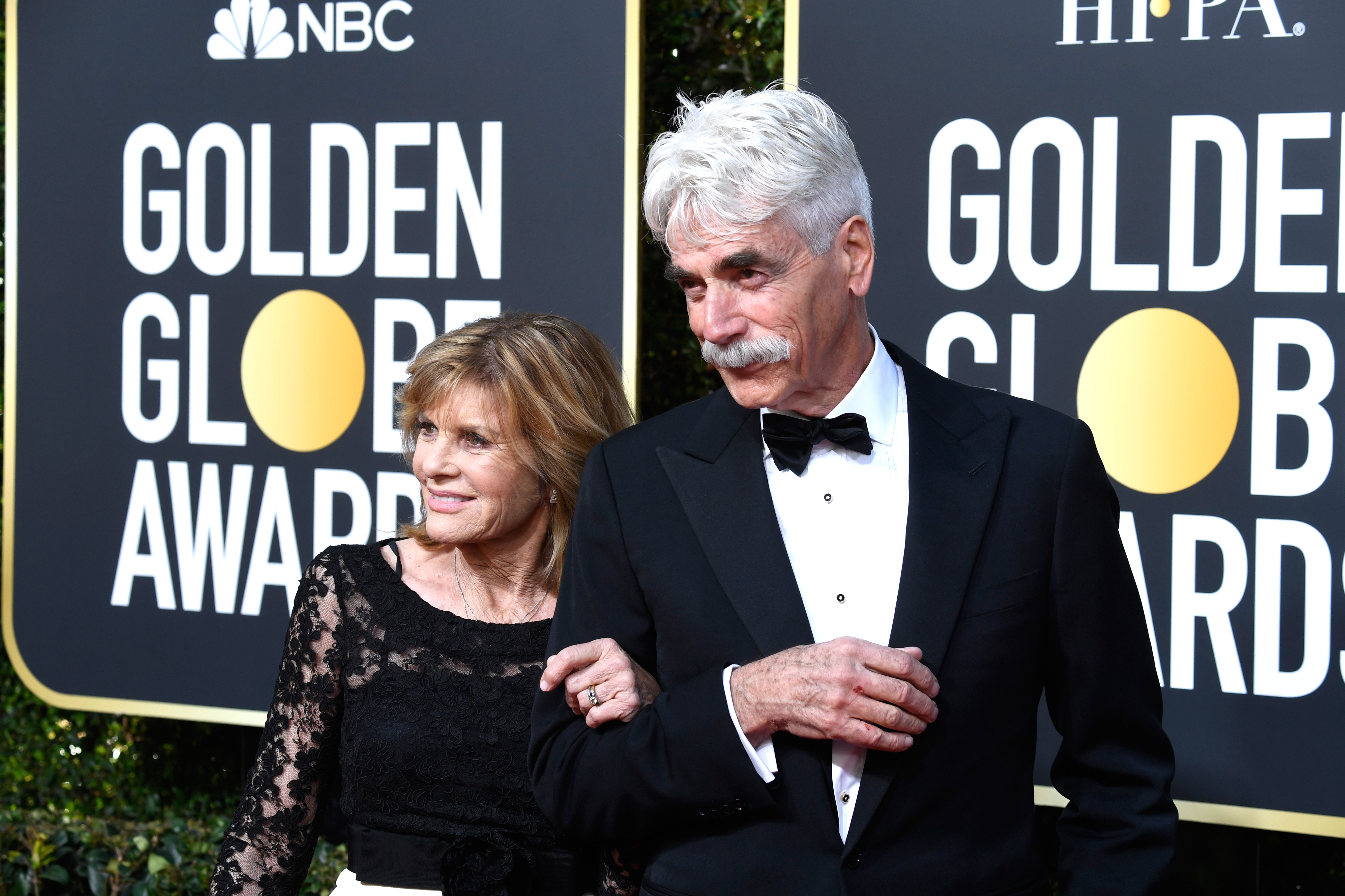 Classic Hollywood elegance was on full display as Katharine Ross and Sam Elliott hit the red carpet for the 76th Annual Golden Globe Awards on January 6, 2019, in Beverly Hills, California. Holding onto Sam's arm, Katharine selected a refined black lace ensemble, while Sam cut a handsome figure in a traditional black tuxedo accented with a crisp white shirt, a matching bow tie, and his iconic white mustache. | Source: Getty Images