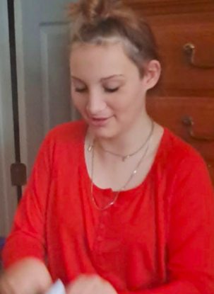 Danika Troy smiling while looking down in a candid photo. | Source: GoFundMe/Lena Ryberg