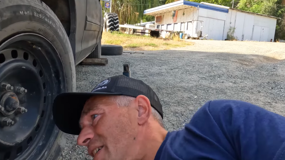 Matt Brown changing a tire in his final YouTube video. | Source: YouTube/Matt Brown