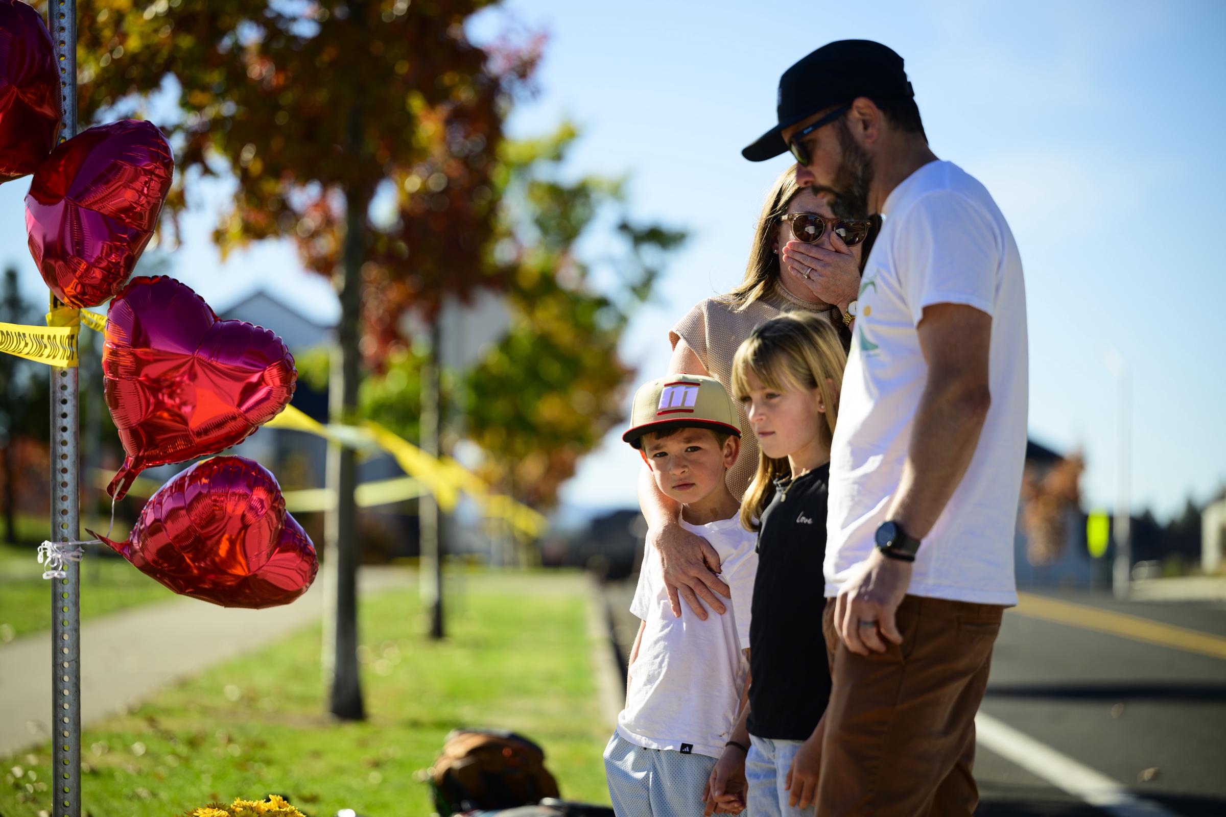 Residents left handwritten messages at community vigils, including the words "NEVER again" and "Be at peace," as Bend mourned the victims. | Source: Getty Images.