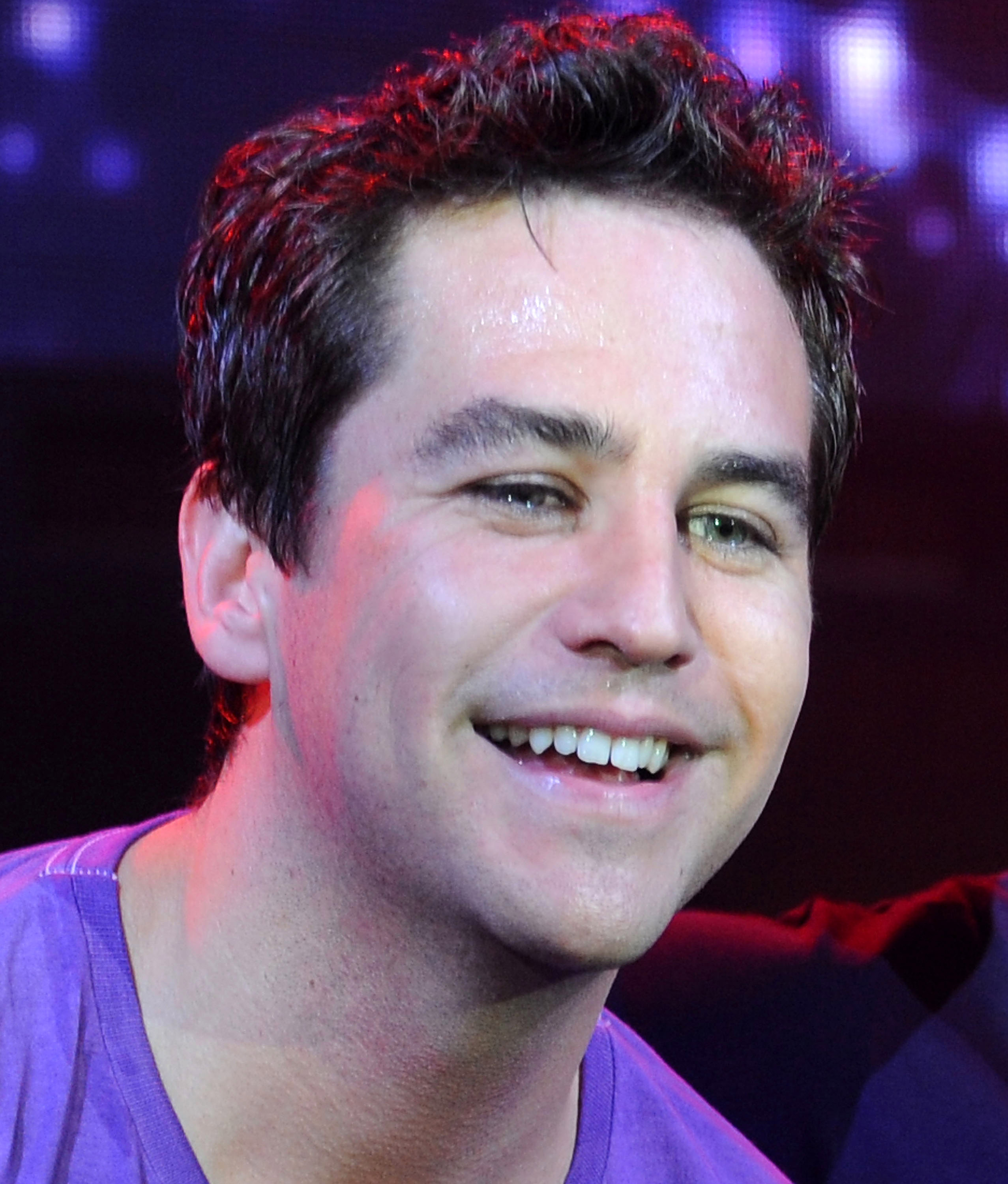 Attending the press launch of the new touring show *Gleemania* at Café de Paris in London, England, the singer appears visibly moved. His eyes seemingly holding back tears as he takes in the emotion of the moment and the journey it represents.
