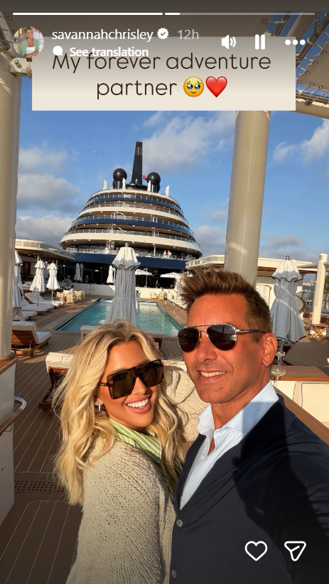 Savannah Chrisley smiles for an outdoor selfie alongside her fiancé, Jason Galanis, while aboard a luxury yacht deck overlooking the pool on October 27, 2026, styling oversized sunglasses and a knit layer with the caption "My forever adventure partner." | Source: Instagram/savannahchrisley