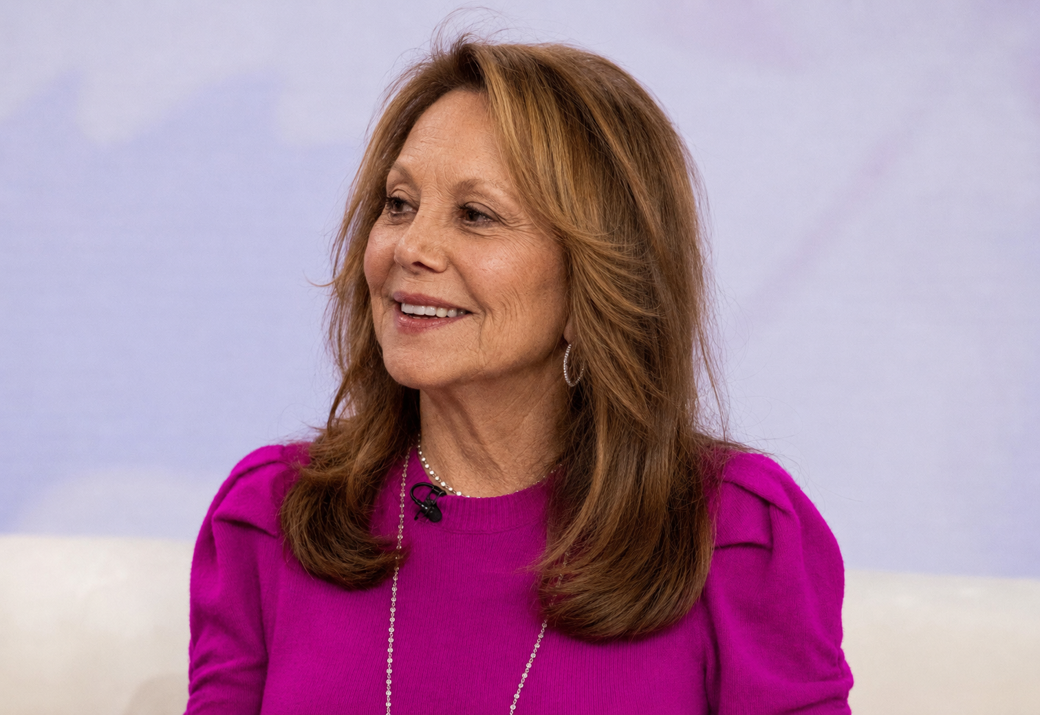 Marlo Thomas appears in yet another AI-generated studio portrait wearing a vivid magenta sweater. | Source: ChatGPT