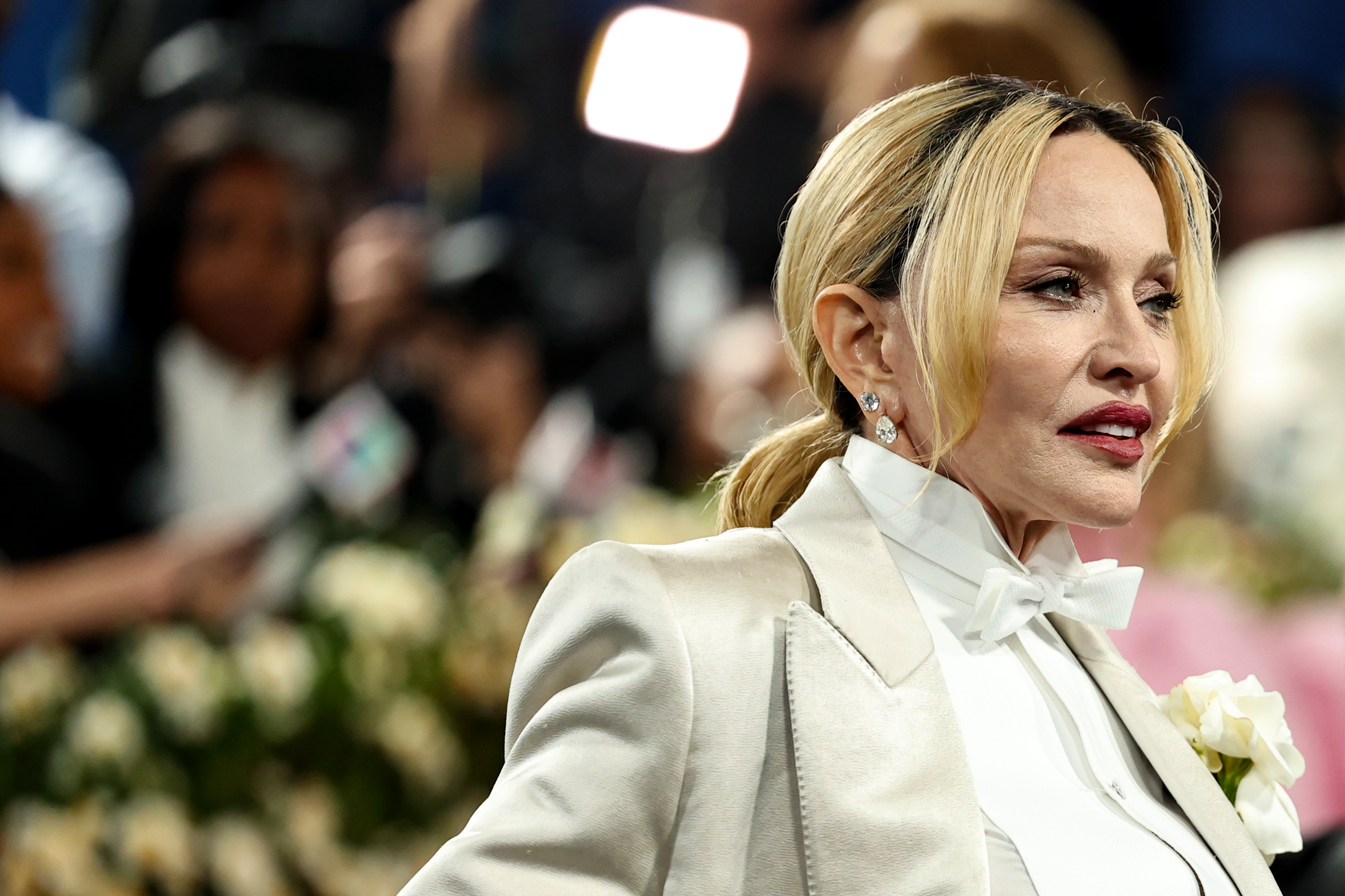 Another photograph from the 2025 Met Gala captures Madonna from the side as she moves through the event. Her blond hair was pulled into a low ponytail, with loose strands framing her face and diamond earrings completing the look. | Source: Getty Images