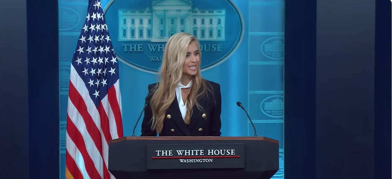 Katie Zacharia speaks at the White House briefing podium during her first press briefing, as body language experts later scrutinized her expressions and delivery. | Source: YouTube/The White House