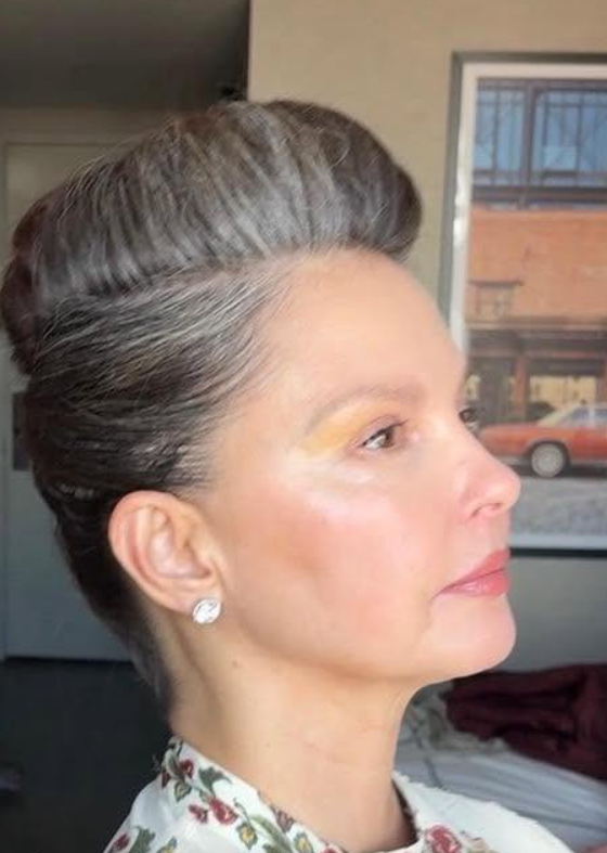 In a 2025 photograph, Ashley Judd's swept-back hairstyle makes the mix of dark and silver strands more noticeable. | Source: Facebook/AshleyJuddOfficial