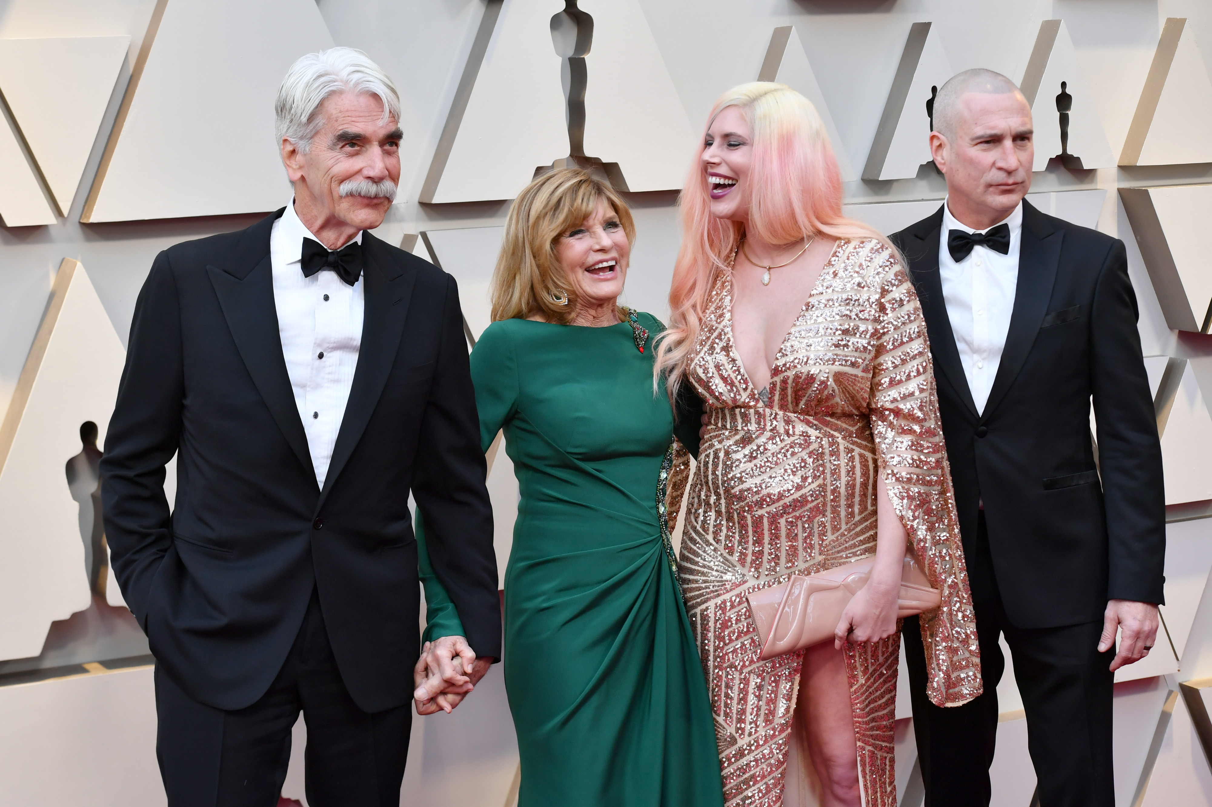 Sam Elliott and Katharine Ross were joined by daughter Cleo Rose Elliott and her partner Randy Christopher at the 91st Annual Academy Awards at Hollywood and Highland on February 24, 2019, in Hollywood, California. The family celebrated Sam's big night in glamorous style, with the actor looking sharp in a classic black tuxedo holding hands with Katharine, who stunned in a rich emerald green gown, while Cleo dazzled in a plunging gold sequined dress paired with pastel pink hair.