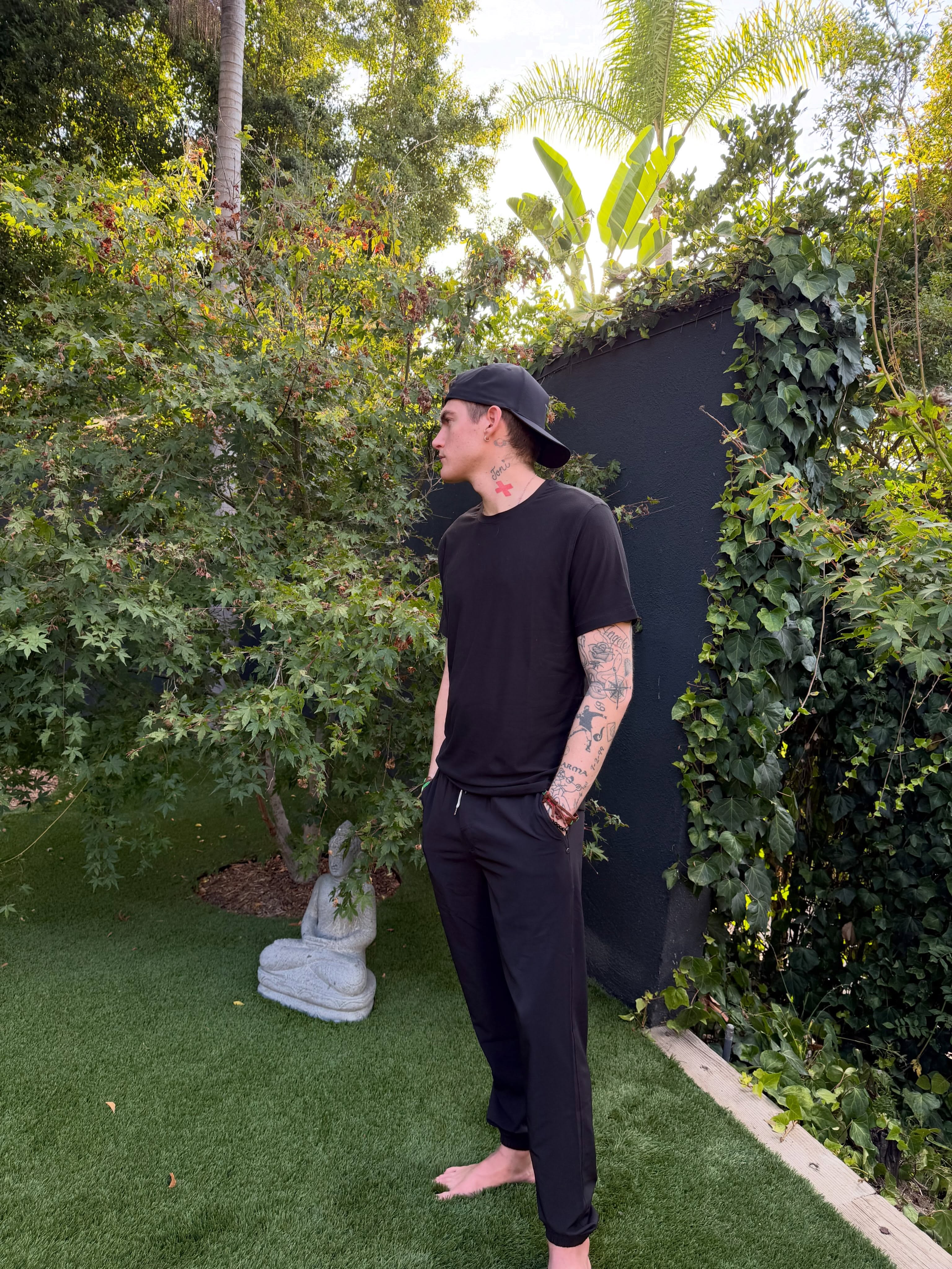 Posing in side profile near a garden Buddha statue, a 27-year-old Presley Gerber gazes into the distance in his final carousel upload. | Source: Instagram/presleygerber