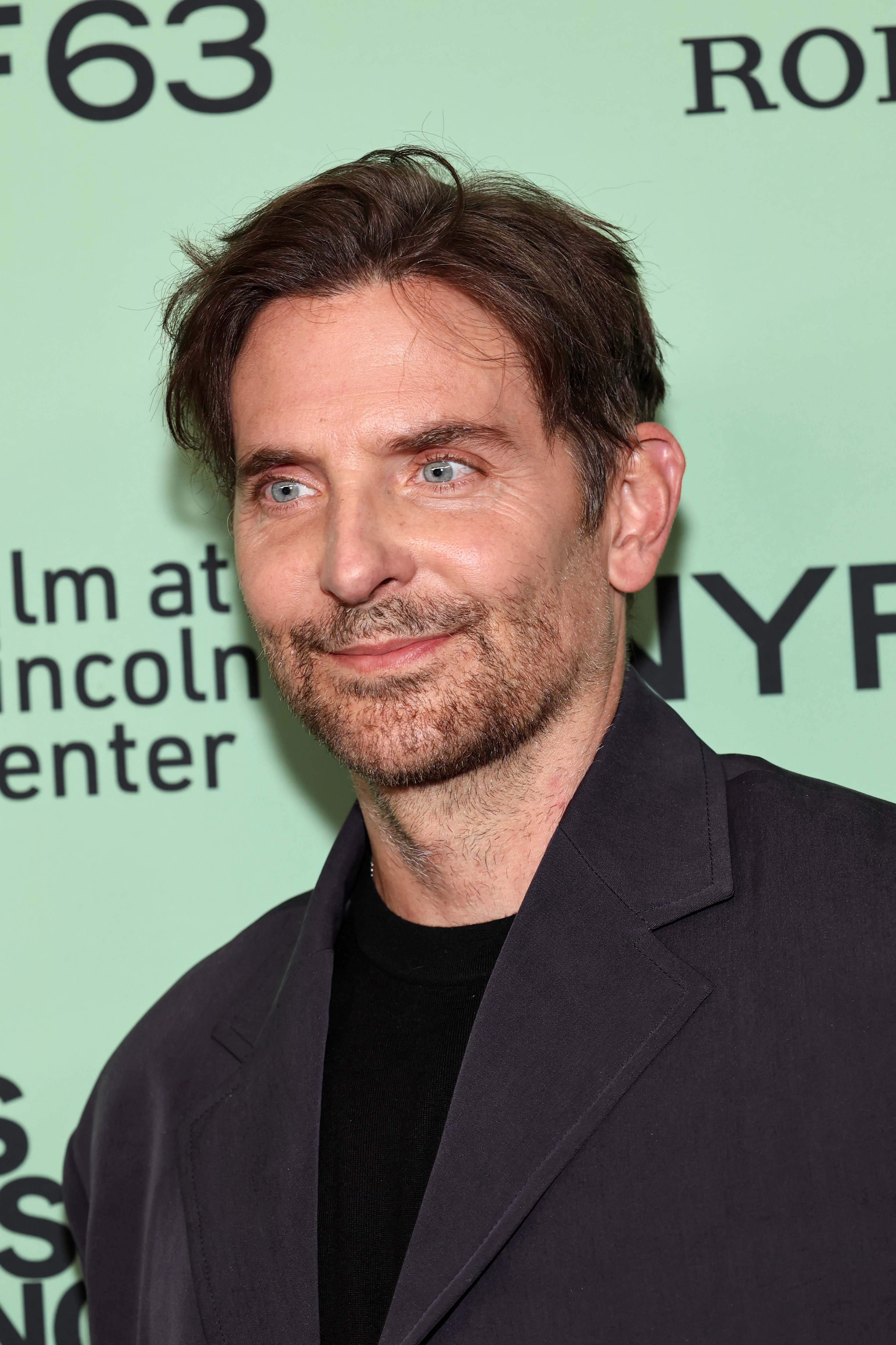 In his most recent shots, Cooper was seen with a subtle, engaging smile and with just a few fine lines tracing the outer corners of his eyes. His short, neat beard shows salt-and-pepper tones, but his expression gave him a slightly puzzling appearance. This was the premiere for "Is This Thing On?" during the 63rd New York Film Festival at Alice Tully Hall, Lincoln Center on October 10, 2025, in New York City.