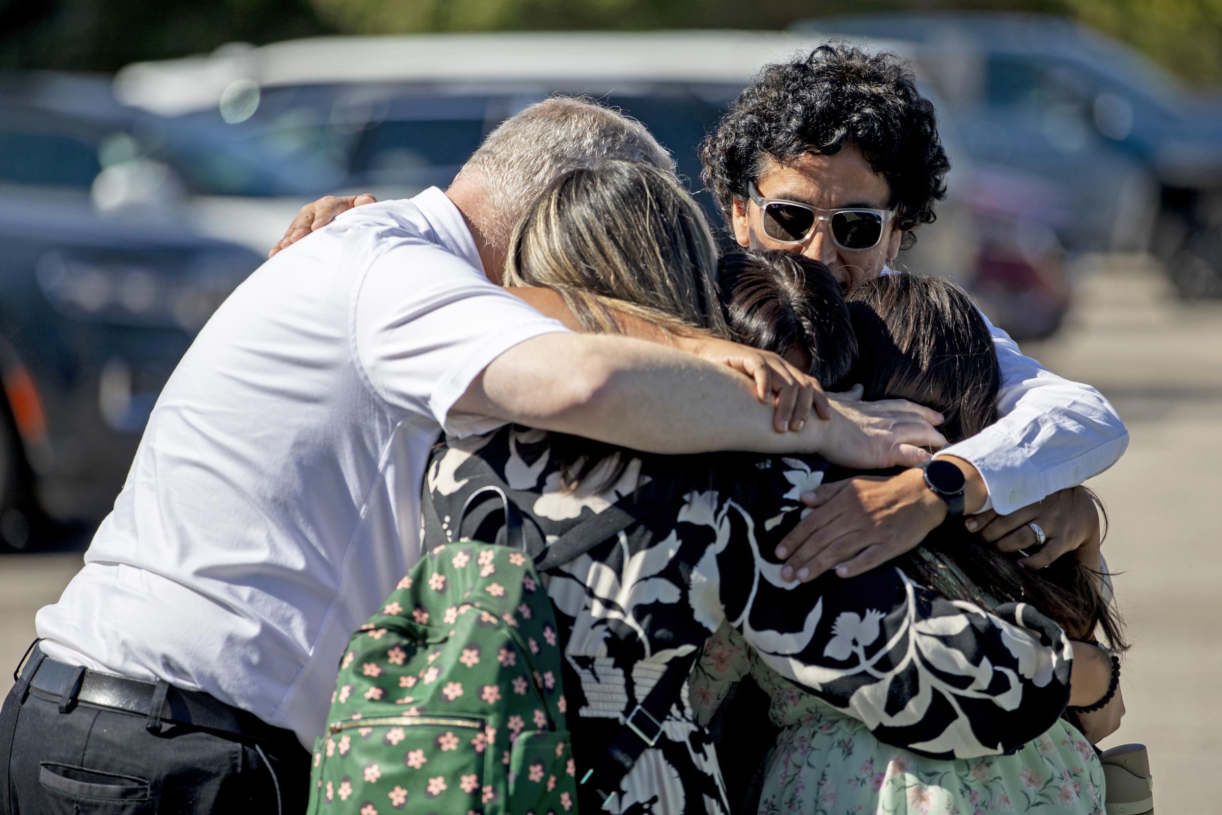 A family emotionally reunites at the Trillium Theater located across the street from the site of a shooting and fire at the Church of Jesus Christ of Latter-day Saints on September 28, 2025, in Grand Blanc, Michigan. | Source: Getty Images