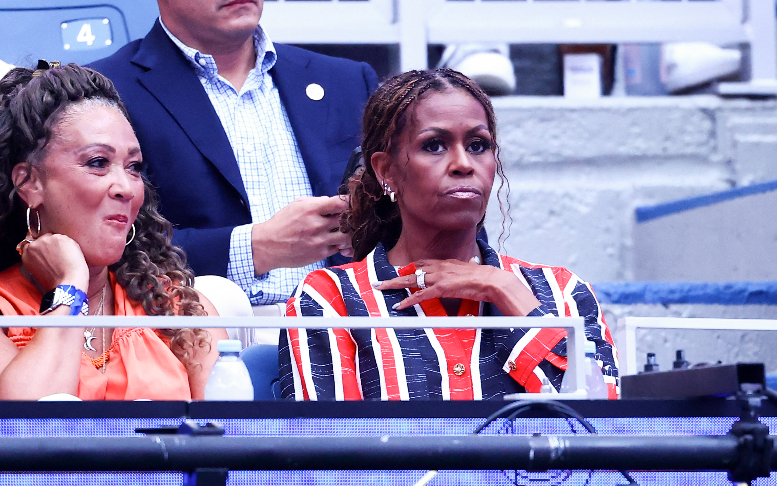Her pale nude manicure added another contrast to the red, white, and navy look — and naturally drew even more attention to the rings whenever she lifted her hands. | Source: Getty Images